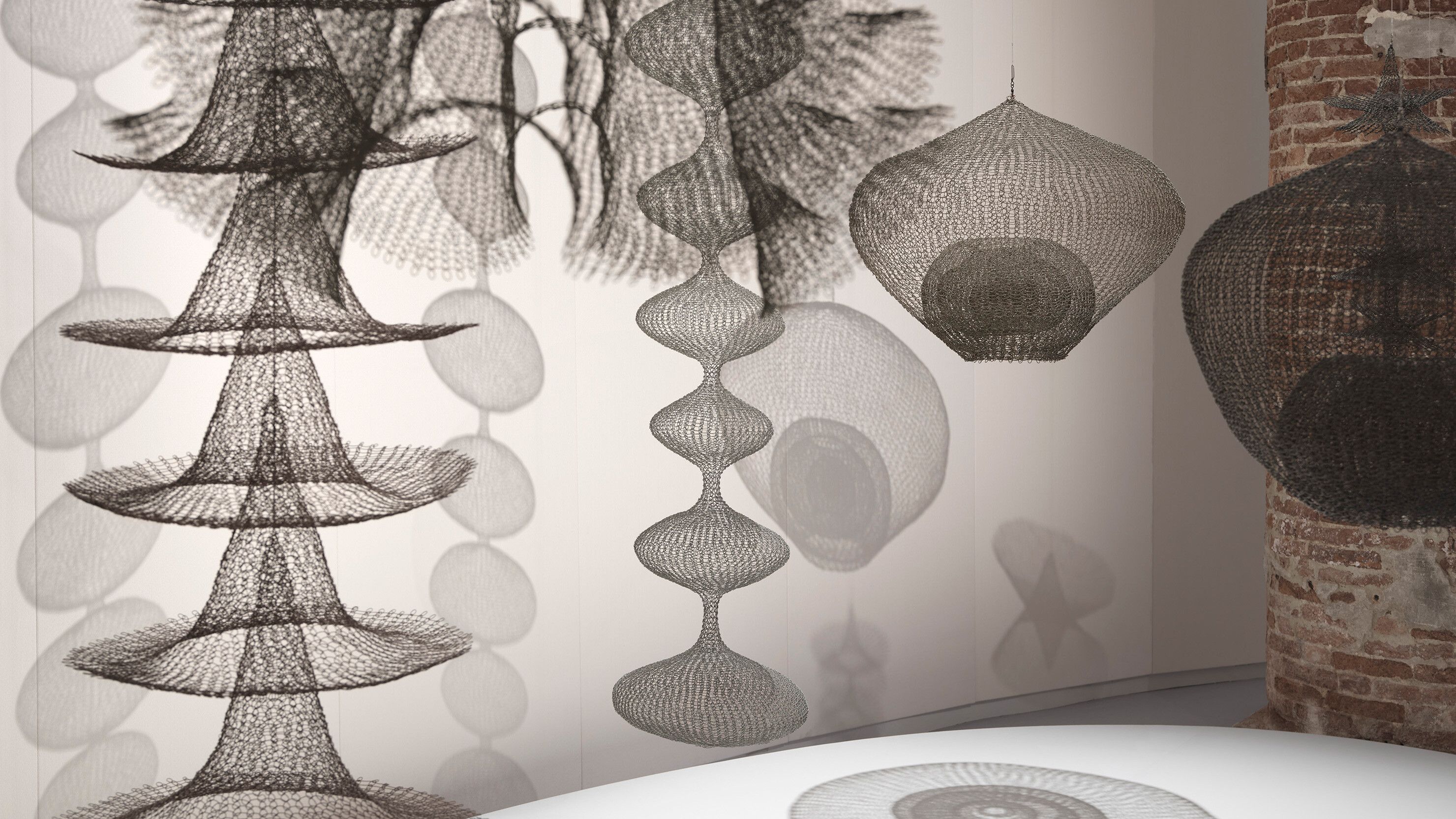 A horizontal installation view featuring Ruth Asawa's sculpture works at the 59th International Art Exhibition of La Biennale di Venezia titled The Milk of Dreams, curated by Cecilia Alemani in 2022
