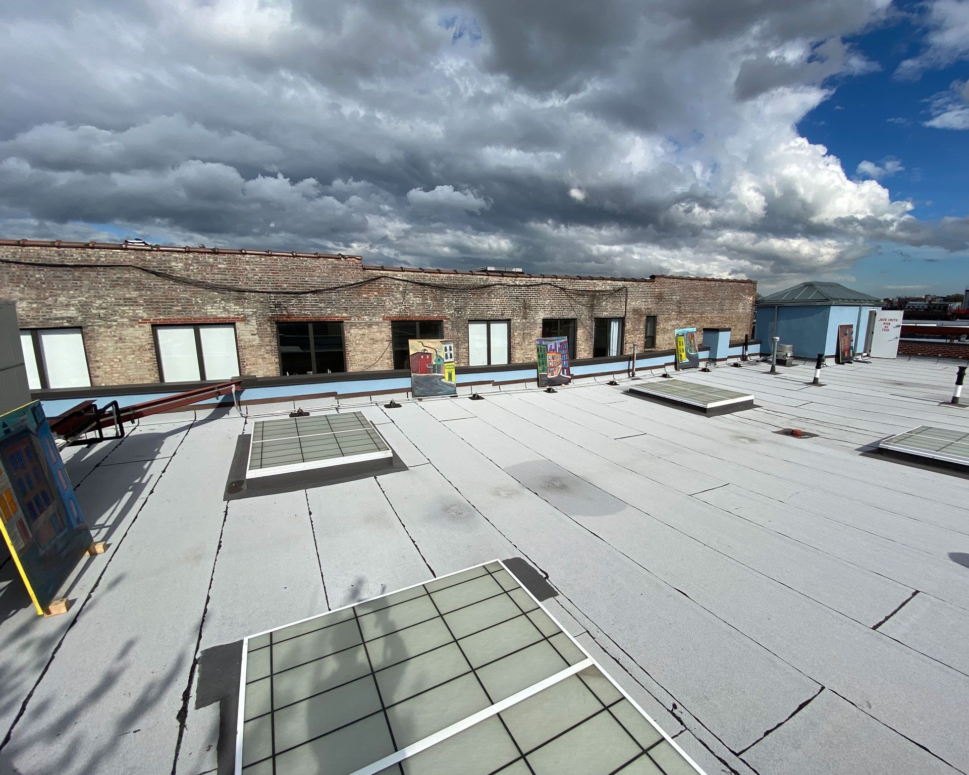 An installation view of the exhibition titled Josh Smith: High As Fuck on the artist's studio roof in Brooklyn, New York, dated 2020.