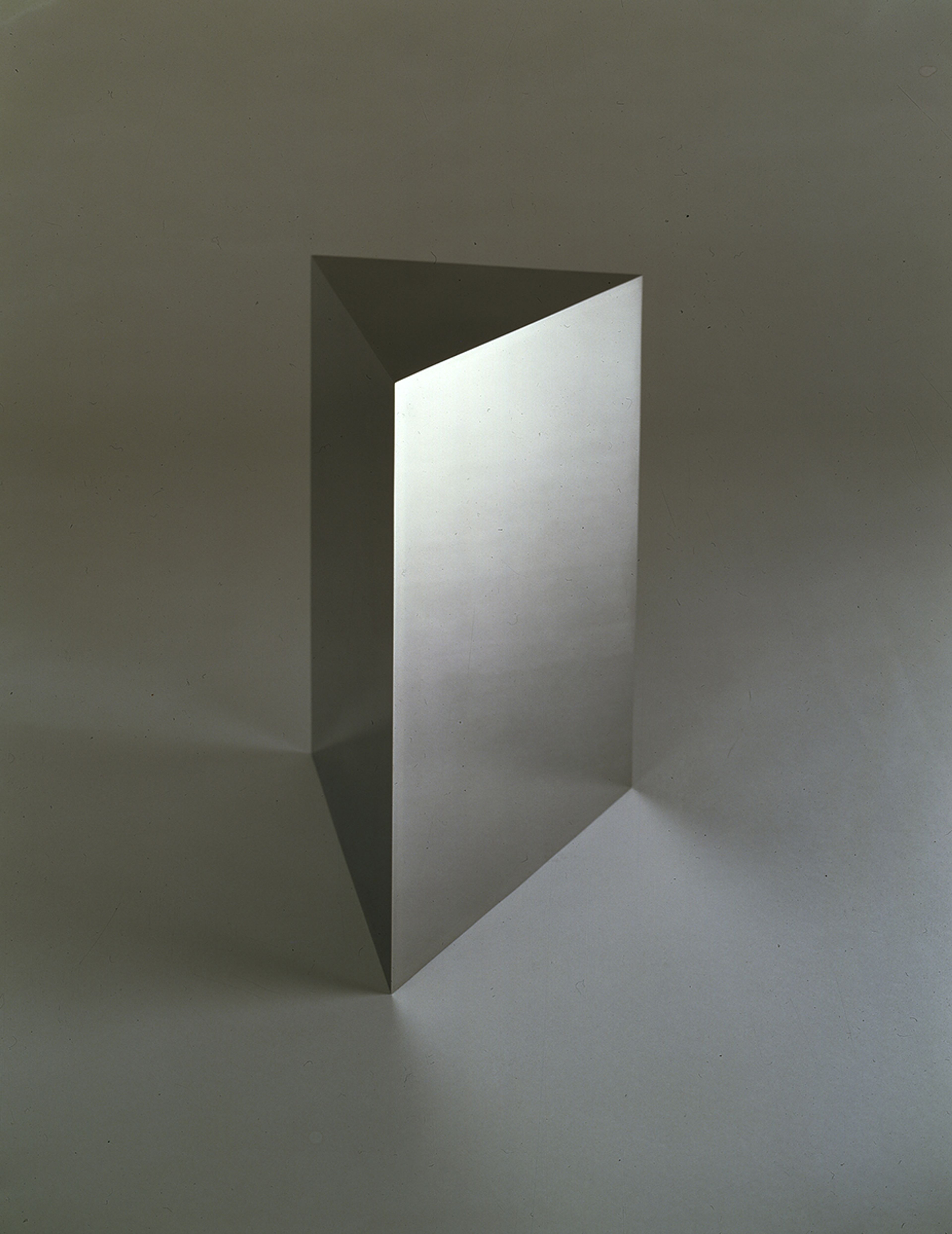 A stainless steel sculpture by John McCracken, titled Ios, dated 1988.