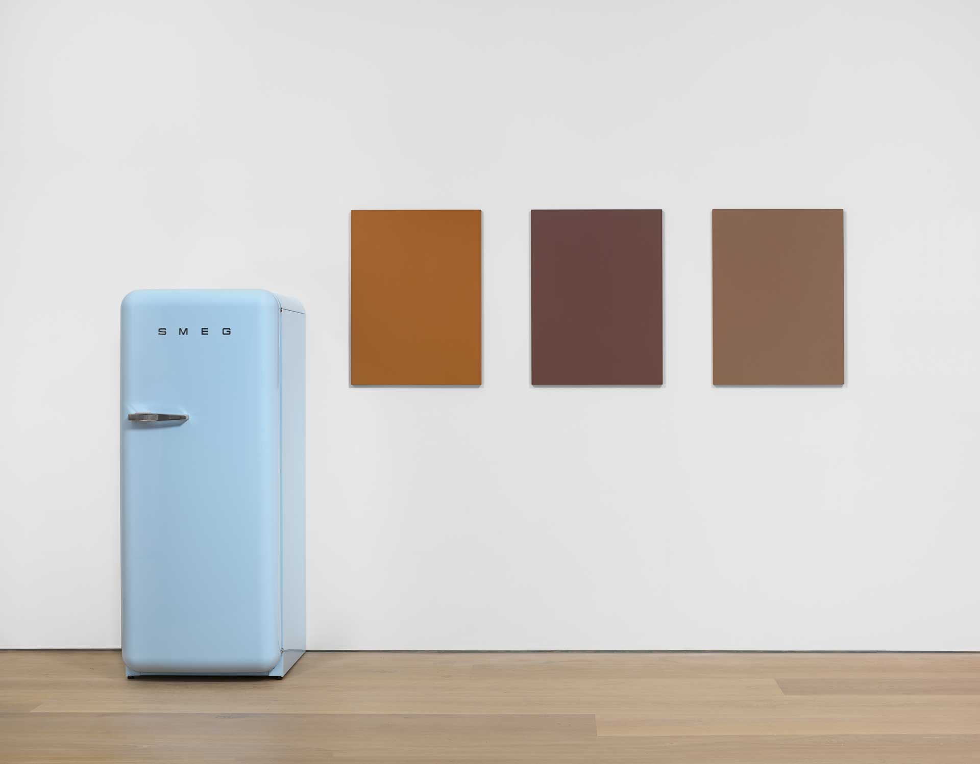 A work by Sherrie Levine comprised of Three oil on mahogany paintings and one SMEG 50s Retro Style refrigerator, titled Pastel Blue SMEG Refrigerator and Renoir Nudes, dated 2016.