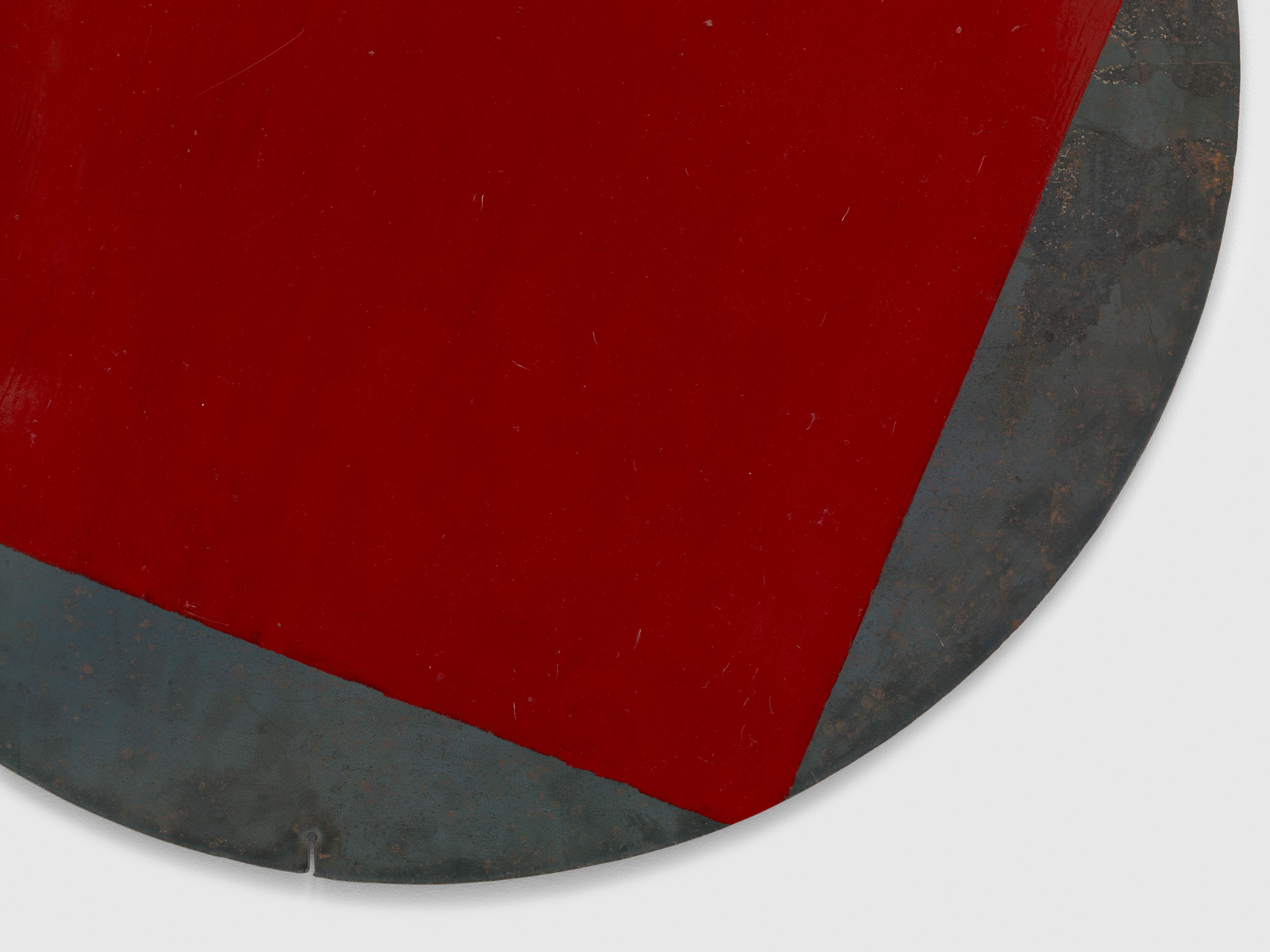 A detail from a painting on steel by Merrill Wagner, titled Red Circle, dated 1990.