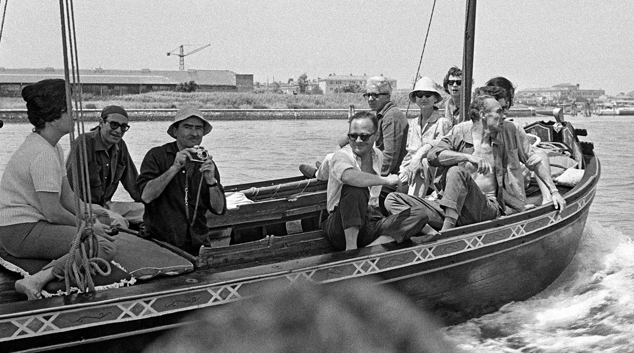 A photo of Alberto Burri (third from left) on a bragozzo going to the Island of Torcello near Venice during the 30th Venice Biennale, 1960; also pictured: Nino Franchina (left of Burri), Basilio Franchina (right of Burri wearing glasses), Afro (behind Franchina), Burri’s wife, Minsa Craig (right of Afro), and Gian Tommaso Liverani, owner of Galleria La Salita, Rome (with his shirt unbuttoned).