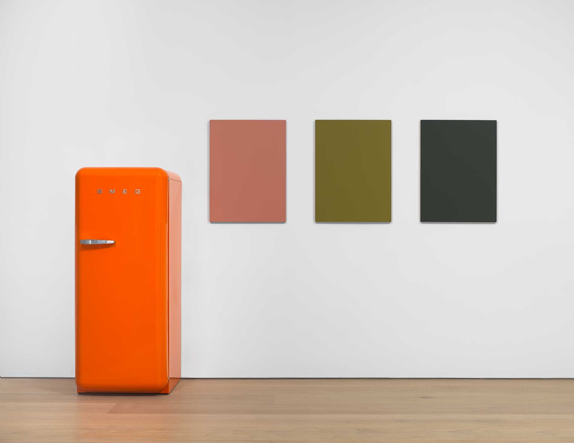 A work by Sherrie Levine comprised of Three oil on mahogany paintings and one SMEG 50s Retro Style refrigerator, titled Orange SMEG Refrigerator and Renoir Nudes, dated 2016.