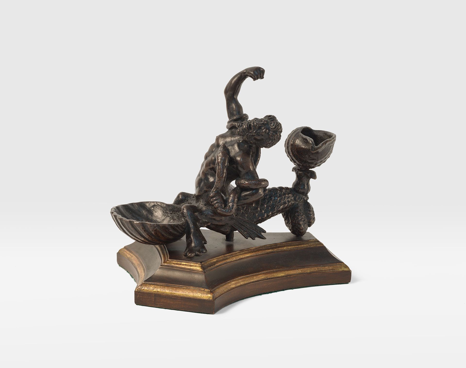 A sculpture from the workshop of Severo di Ravenna, titled An Inkstand in the form of a Triton Wrestling with Snakes, dated in the early 16th century.