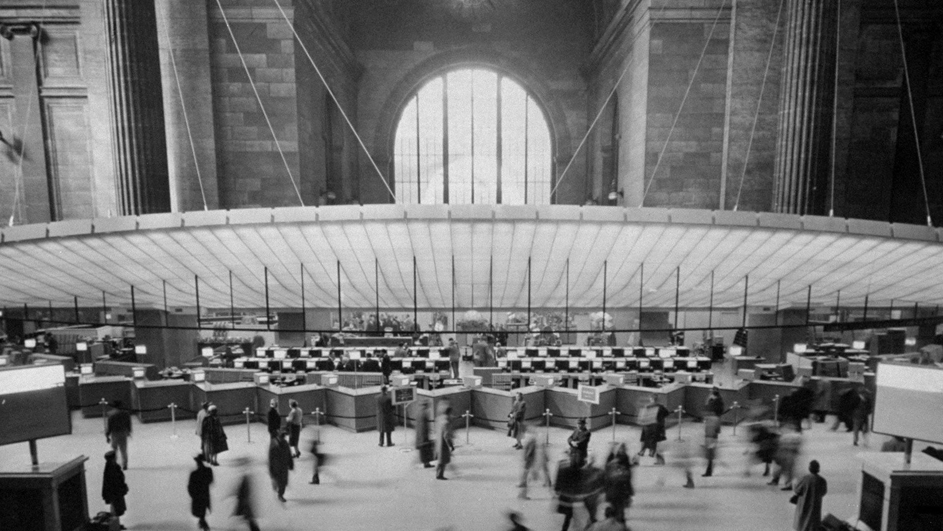 A photograph of an electronic ticket window in Pennsylvania Station, dated 1957