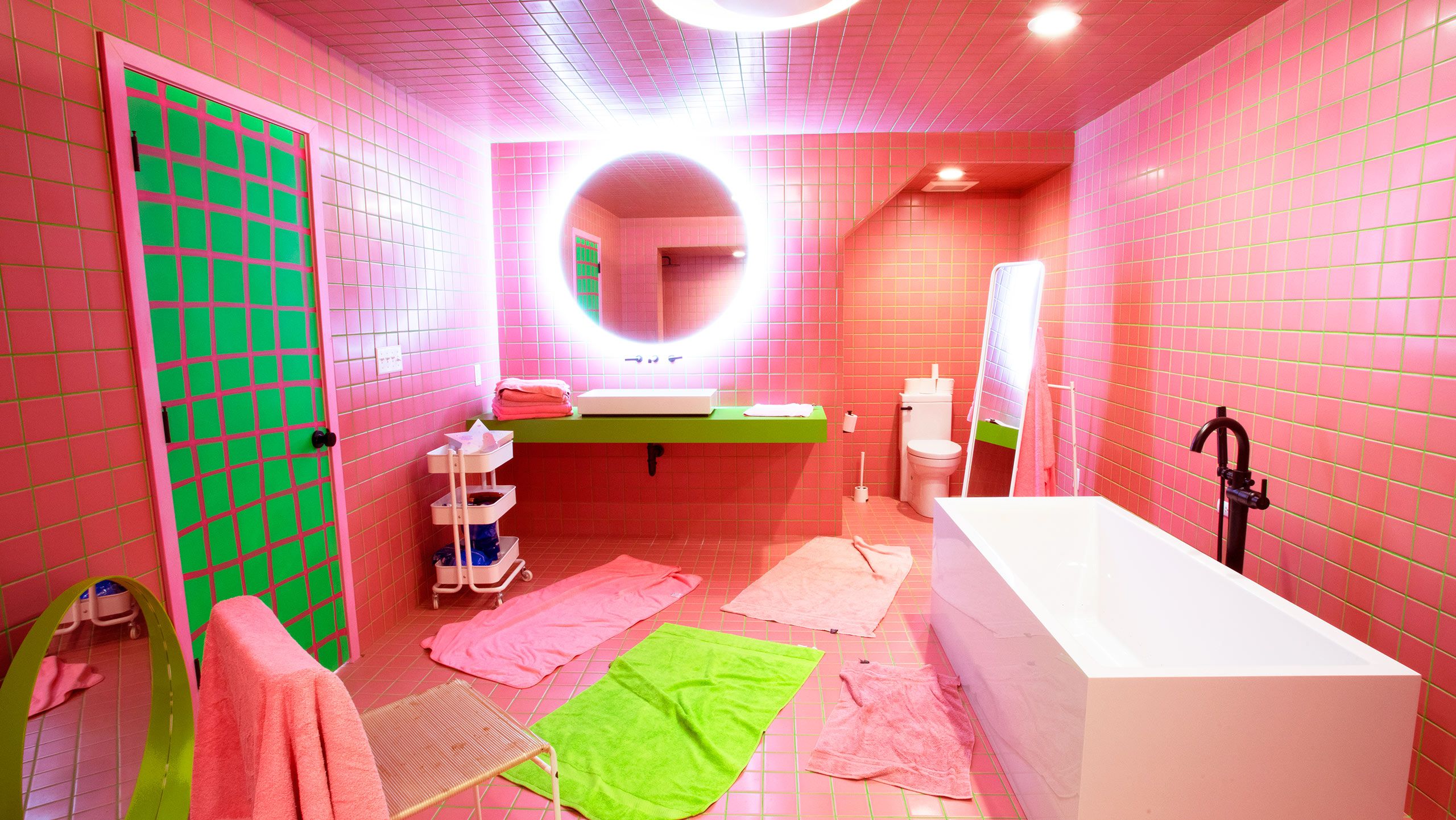 Photo by Sarah Carmody of A bathroom at Bernhardt’s gallery and storage building in St. Louis, Dragon, Crab and Turtle, which she designed with pink tile and green grout. 
