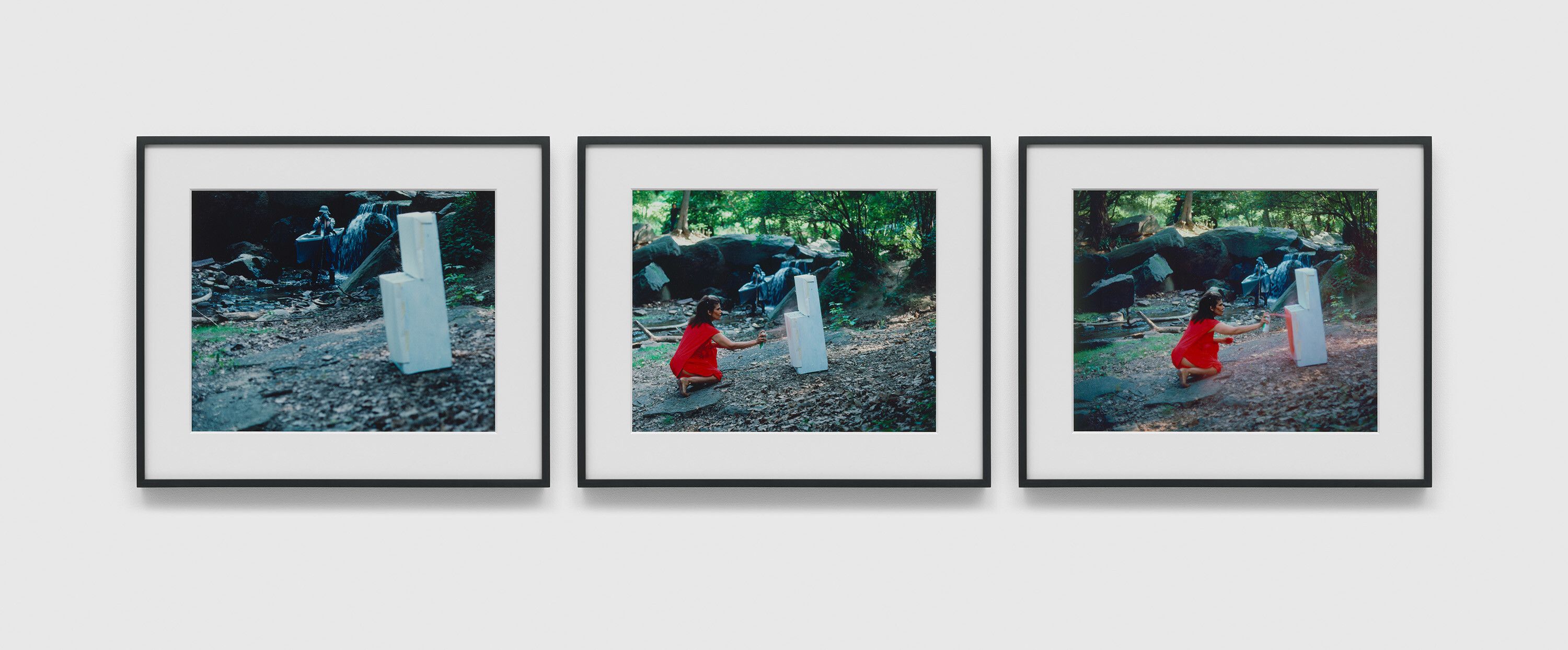 A photograph by Lorraine O’Grady, titled She Descends to the Stream Where the White Stove Is Standing; The Stove Becomes More and More Red; The Woman in Red Starts Painting the Stove Her Own Color A selection of three (3) digital chromogenic prints from the Rivers, First Draft series, dated in 1982 and 2015.