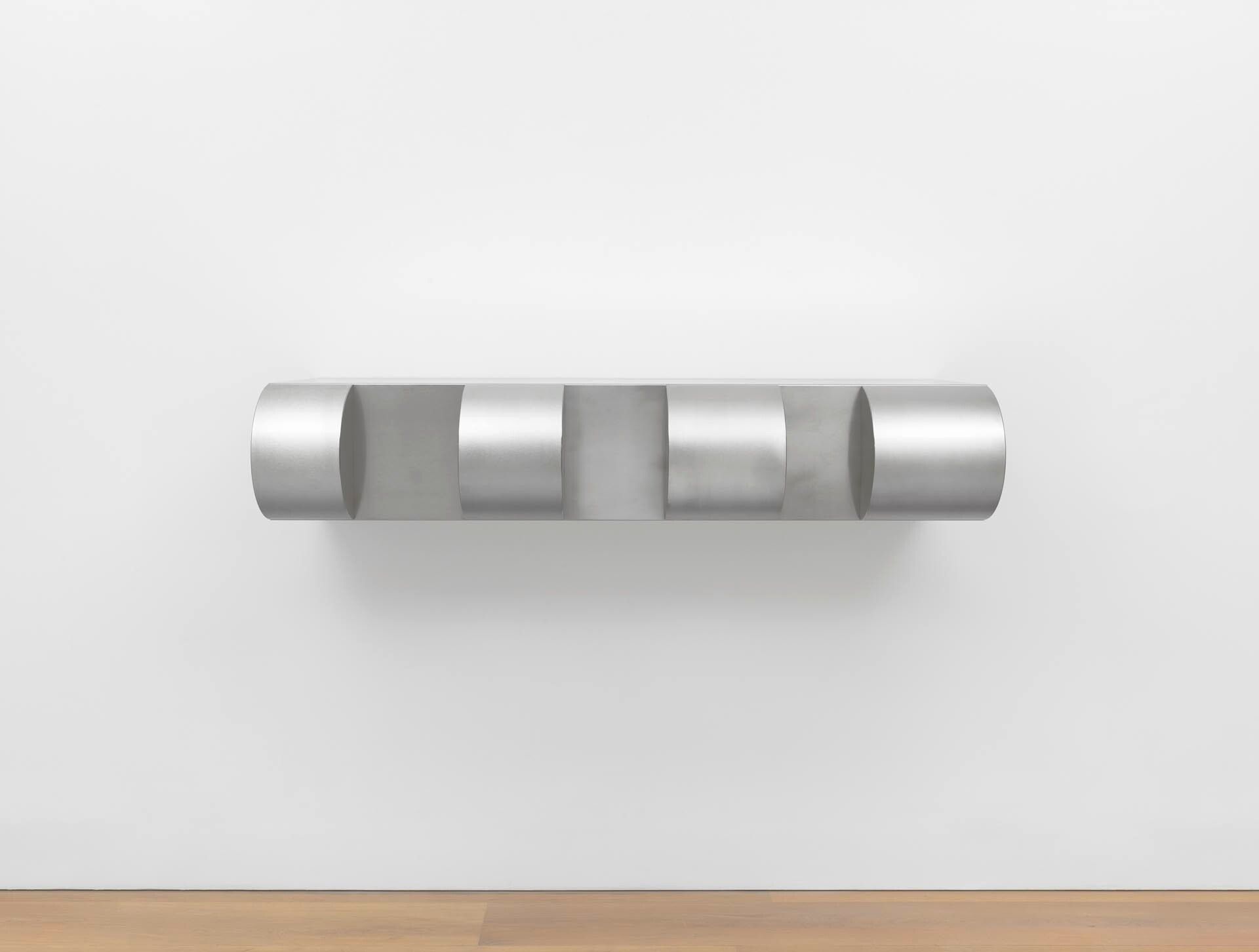 An untitled stainless steel sculpture by Donald Judd, dated 1976.