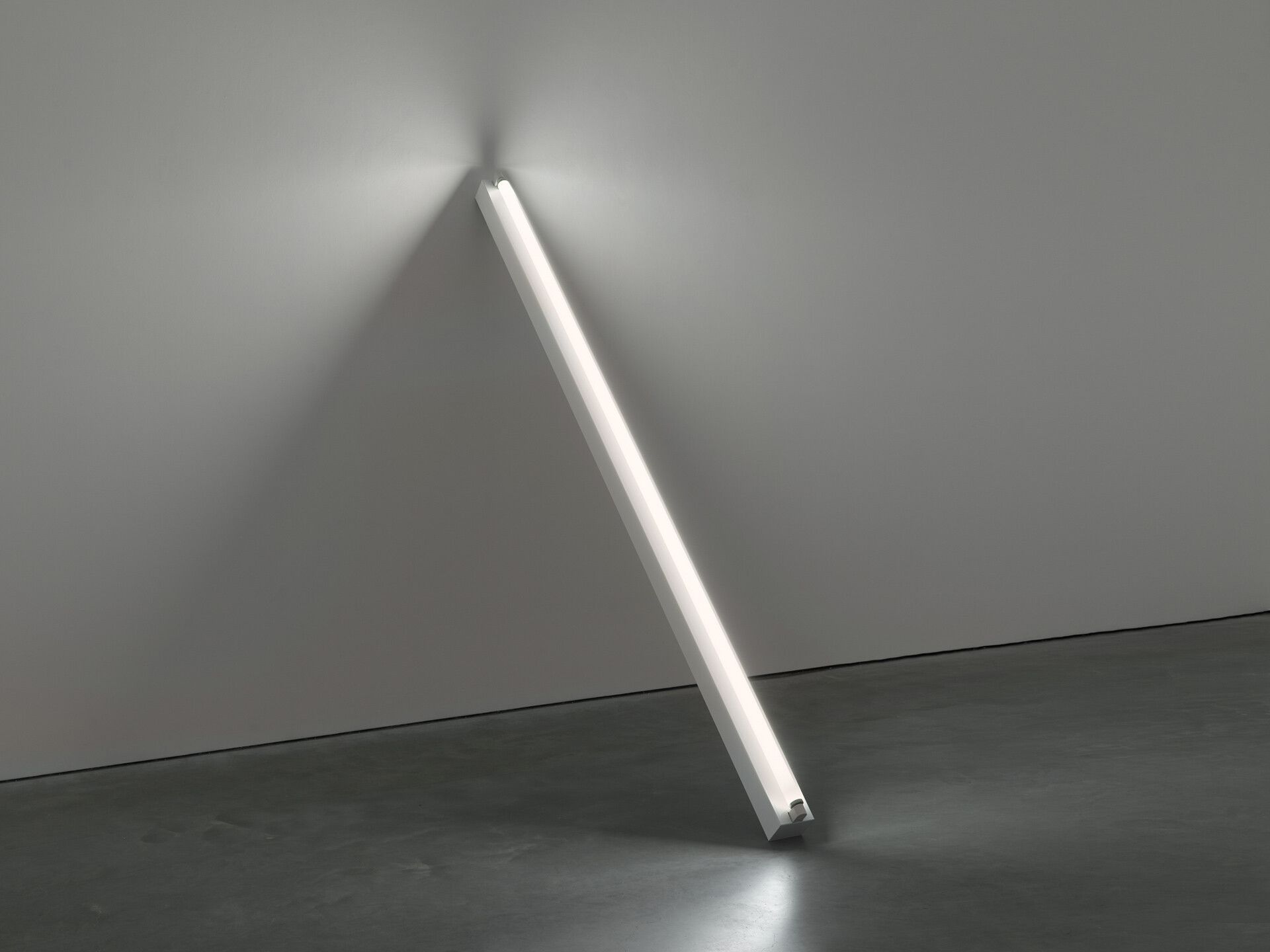 A cool white fluorescent light sculpture by Dan Flavin, titled "a leaning diagonal" of March 27, 1964 (to David Smith), dated 1964.