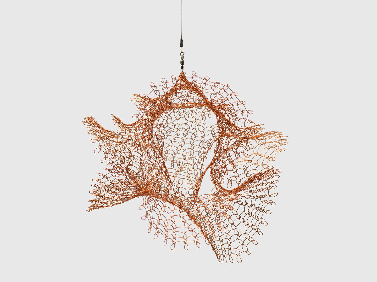 A hanging copper wire sculpture by Ruth Asawa, titled Untitled (S.742, Hanging Single Section, Open Windows Form), circa 1976-1979.