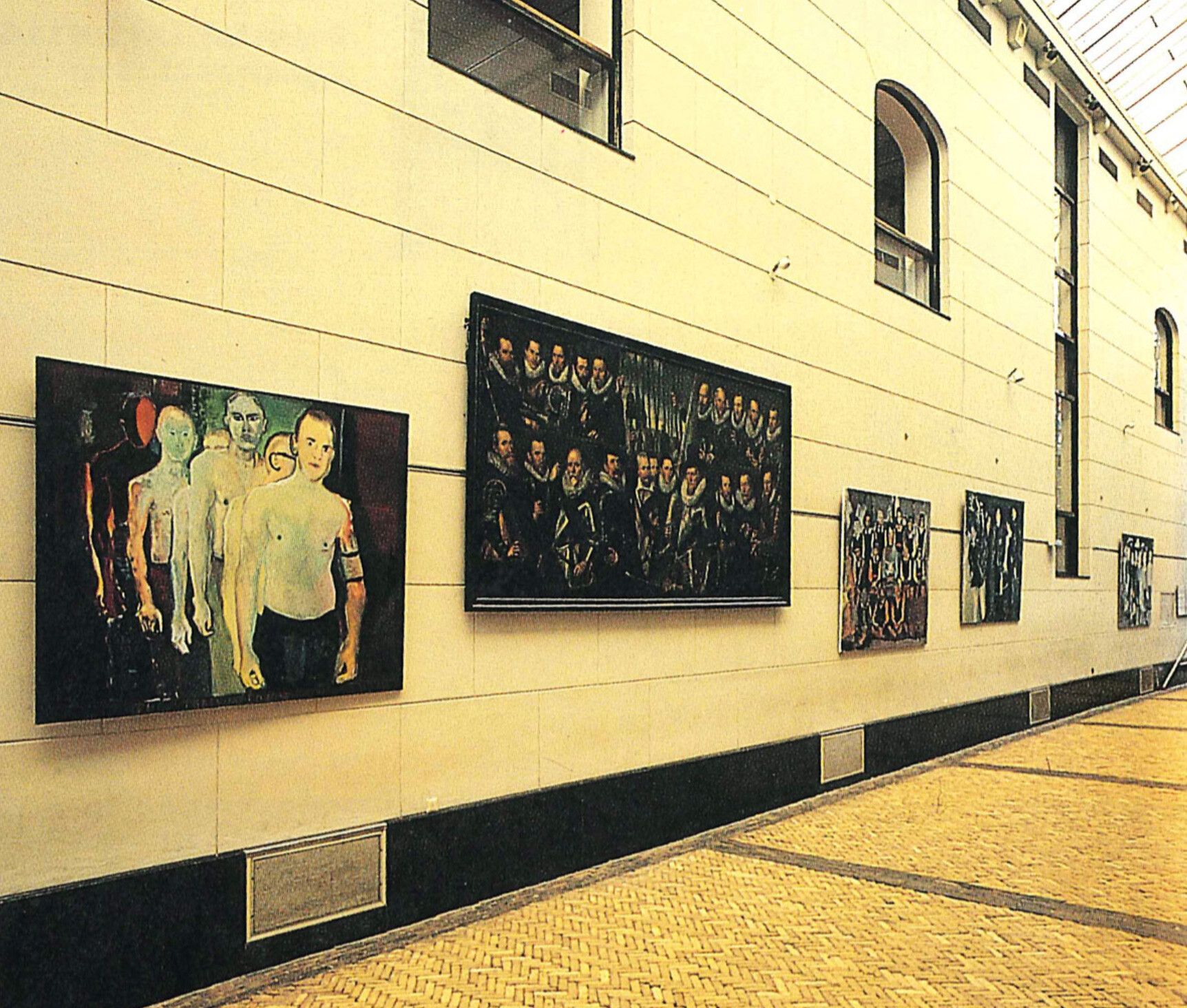 An Installation view, of Century 87: Kunst van nu ontmoet Amsterdams verleden, 1987, Amsterdam Historisch Museum, with (from left to right) Marlene Dumas, The Training Course, dated 1987-1990 (early version); Frans Badens, Civic Guardsmen from a company of the Crossbow Civic Guard, 1603-1618; Marlene Dumas, titled The Teacher (Sub B), dated 1987; Marlene Dumas, titled The Schoolboys, dated 1986-1987; and Marlene Dumas, titled The Turkish Schoolgirls, dated 1987