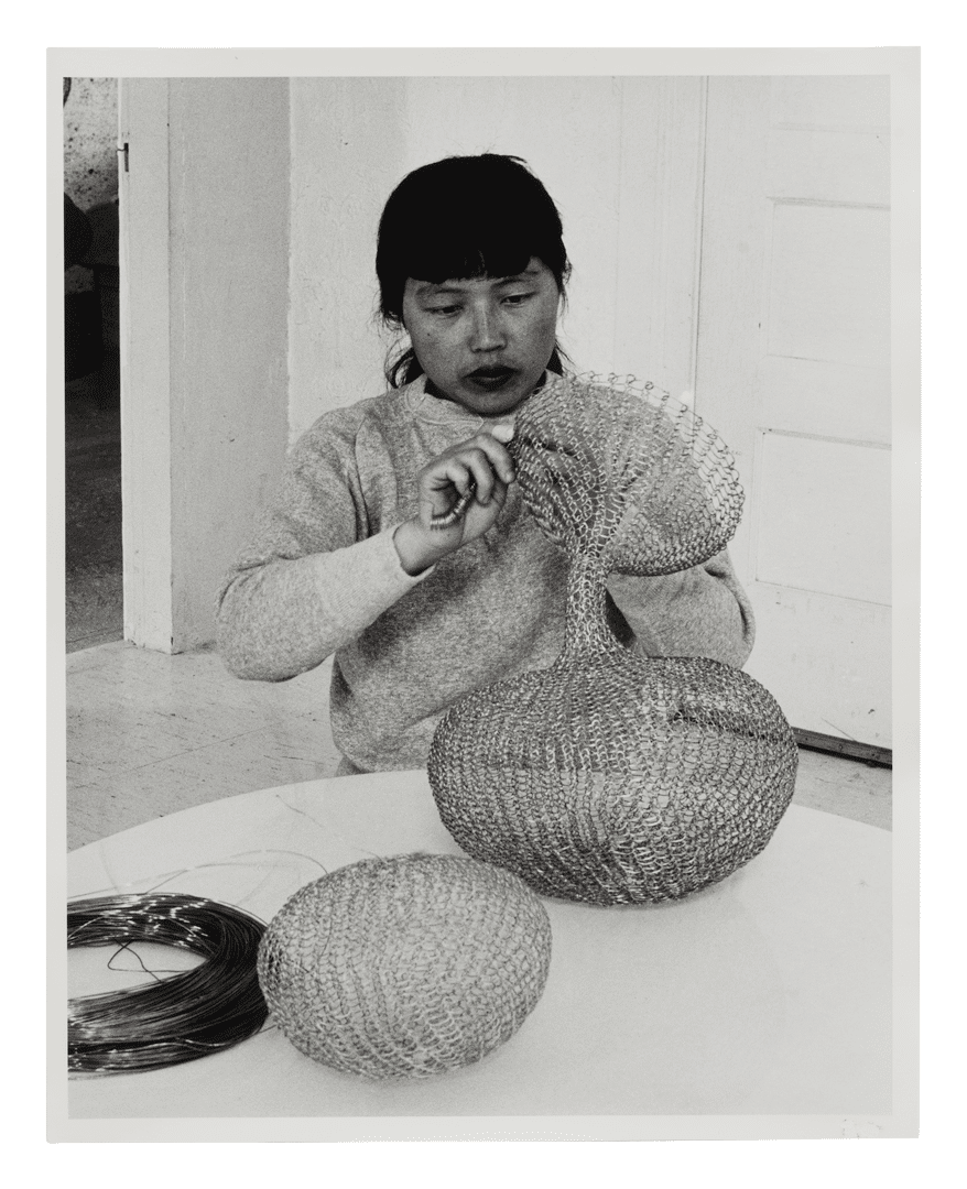 A gelatin silver print by Imogen Cunningham, titled, Ruth Asawa and Her Wire Sculpture 2, dated 1956.