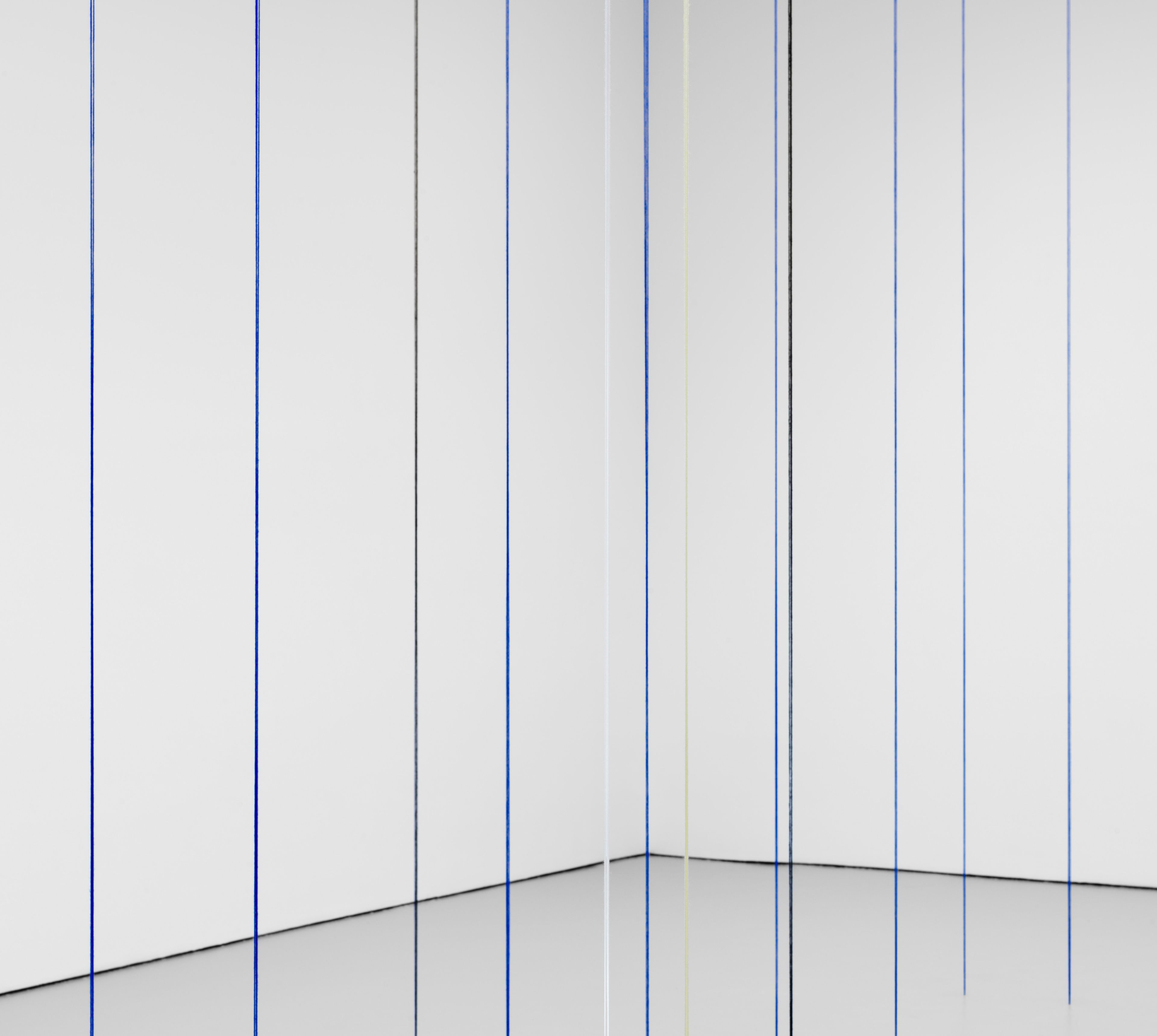 A detail from a black, blue, white, and light yellow acrylic yarn artwork by Fred Sandback, titled Untitled (Sculptural Study, Eighteen-part Architectonic Vertical Construction), 1987 and 2018.