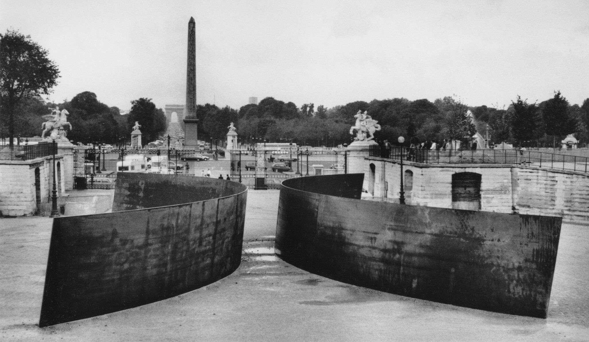 A photograph by Dirk Reinartz featuring a sculpture titled Clara-Clara by Richard Serra, dated 1983, it consists of weathering steel, Two identical conical sections inverted relative to each other