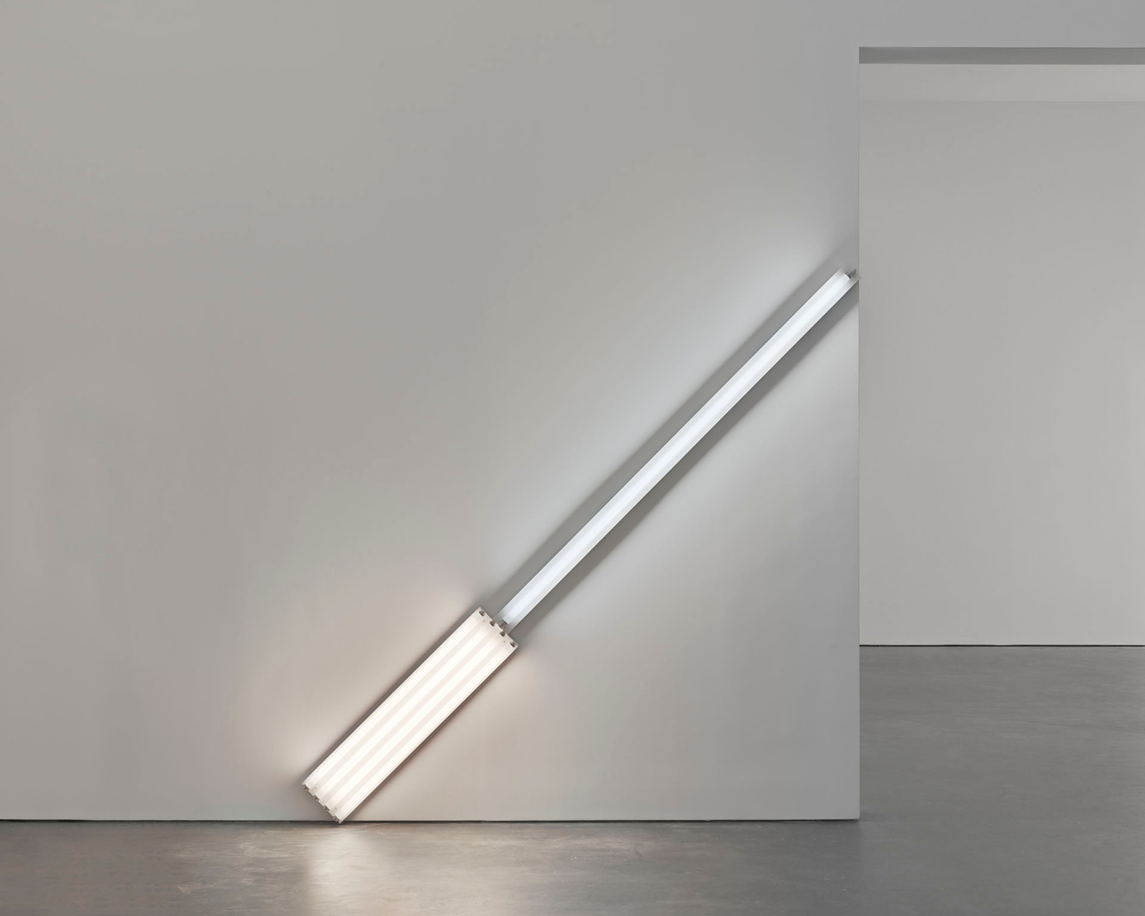 A sculpture in daylight and cool white fluorescent light by Dan Flavin, titled alternate diagonals of March 2, 1964 (to Don Judd), dated 1964.