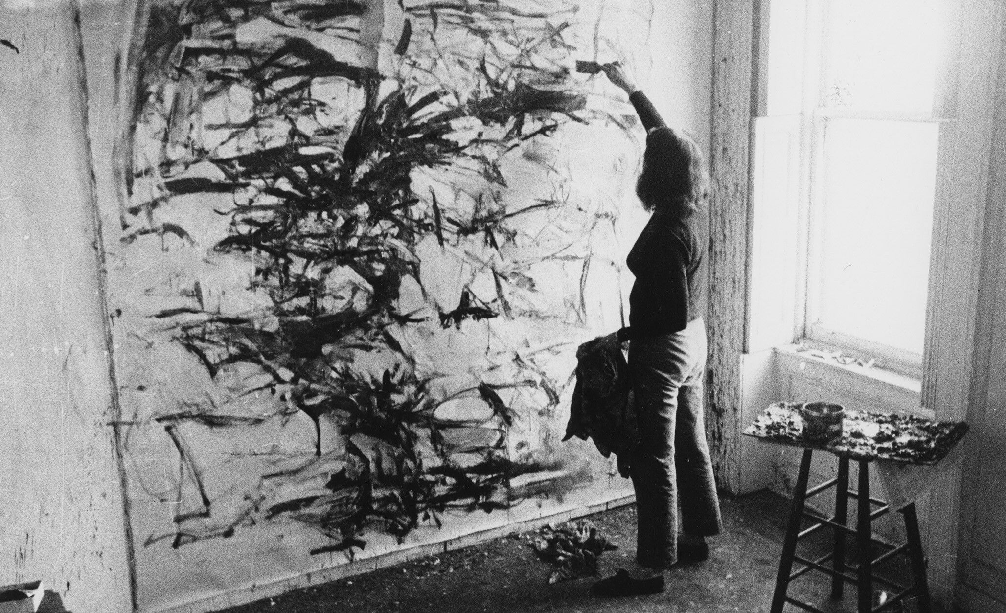 A photo of Joan Mitchell in her St. Mark’s Place studio in 1957. Photo by Joan Mitchell and Rudy Burckhardt.