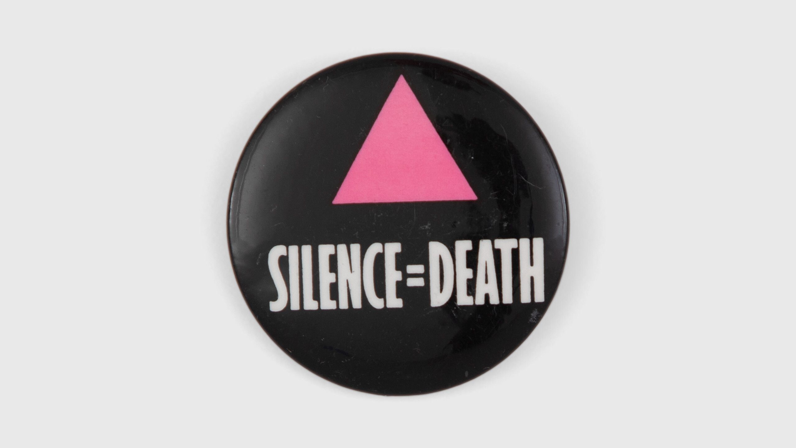 A photo of Silence=Death pins.