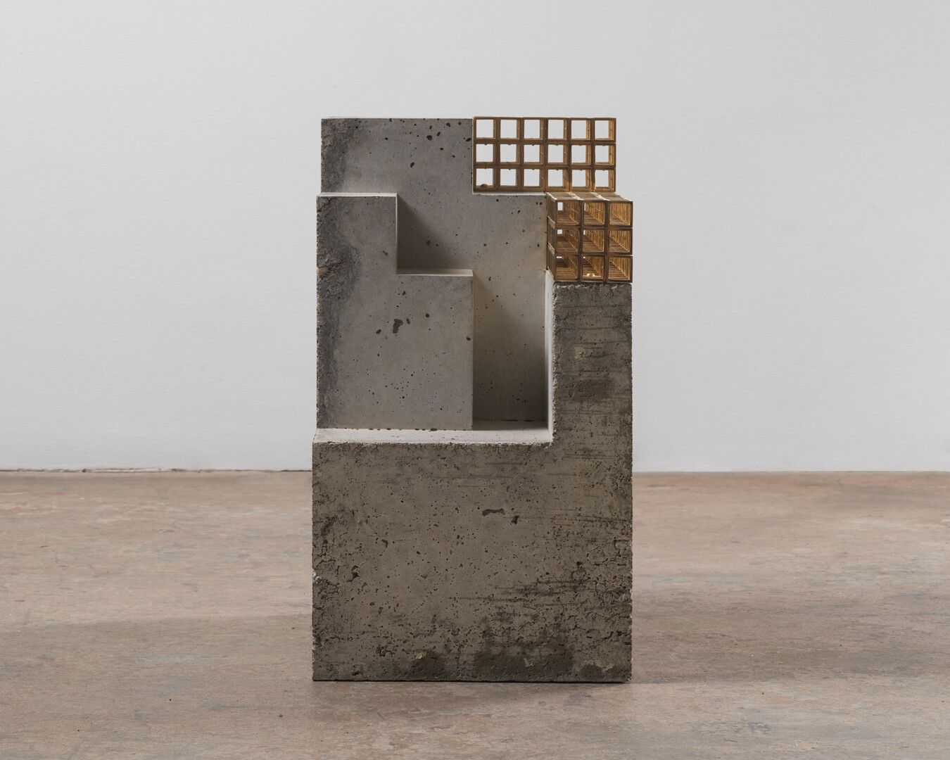 An untitled concrete and brass sculpture by Carol Bove, dated 2014.