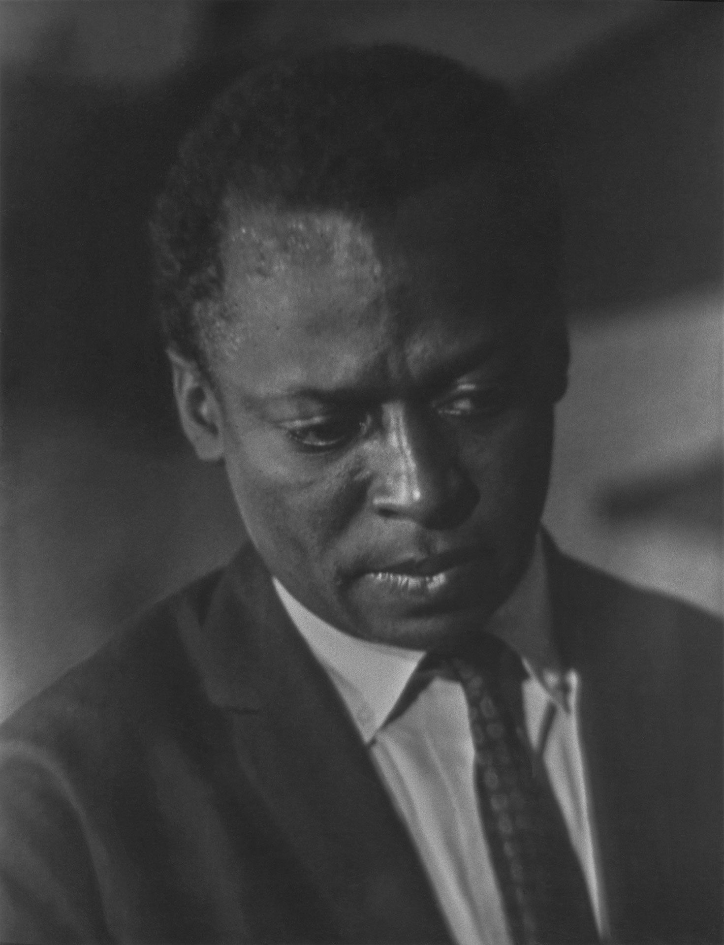 A silver gelatin print by Roy DeCarava, titled Miles Davis, dated 1957.