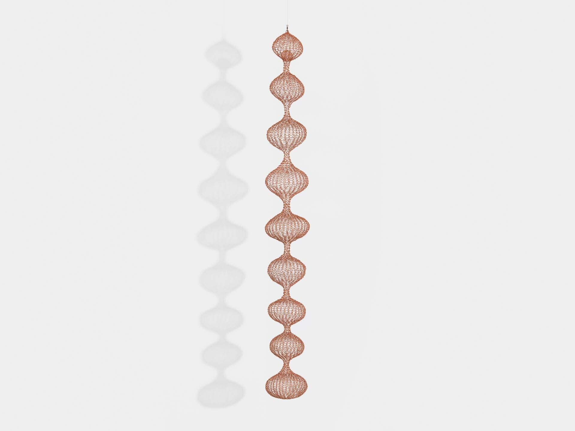 A sculpture by Ruth Asawa, titled Untitled (S.525, Hanging, Miniature Nine-Lobed Single Layer Continuous Form with Sphere in Top Lobe), dated circa 1980 to 1989.