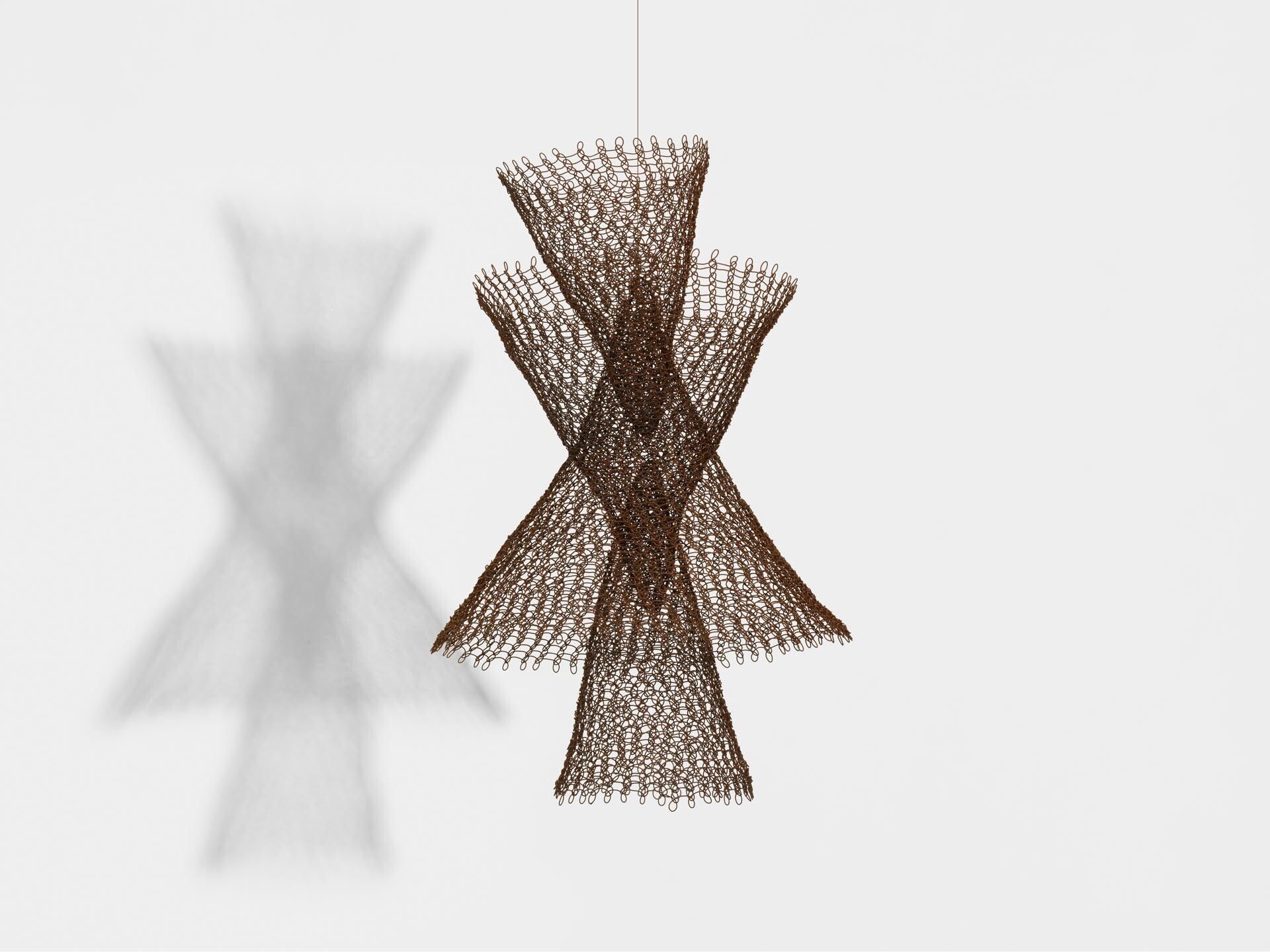 A sculpture by Ruth Asawa, titled Untitled (S.563, Hanging Six Lobed Form with Two Interior Spheres), dated 1956.