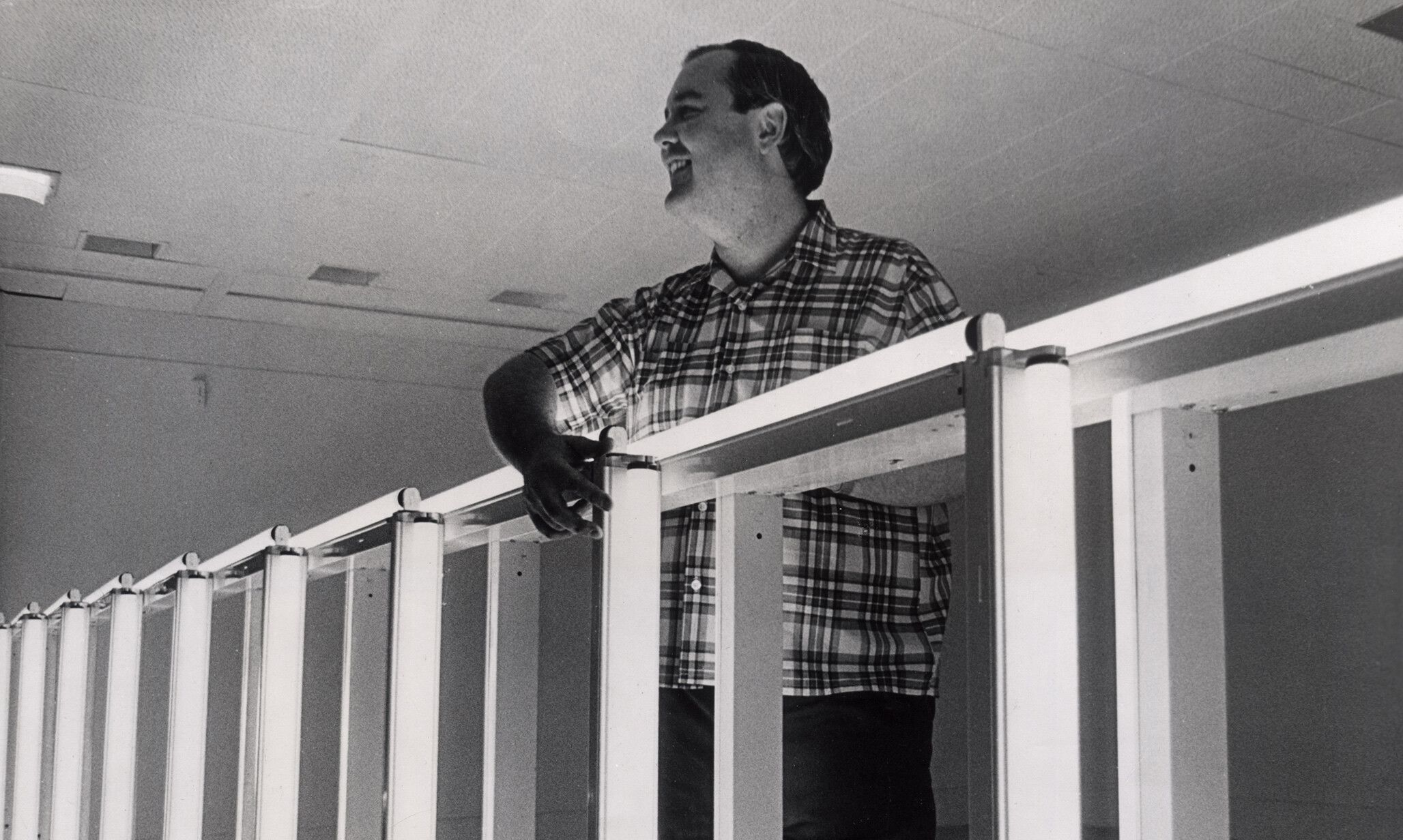 Dan Flavin installing his solo exhibition fluorescent light, etc. from Dan Flavin, dated 1969