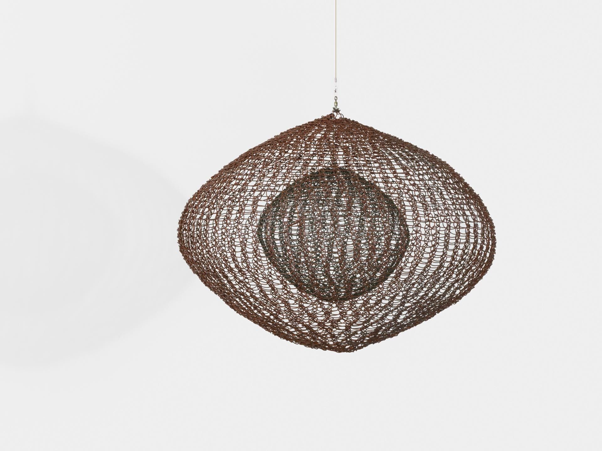 A sculpture by Ruth Asawa, titled Untitled (S.563, Hanging Six Lobed Form with Two Interior Spheres), dated 1956.