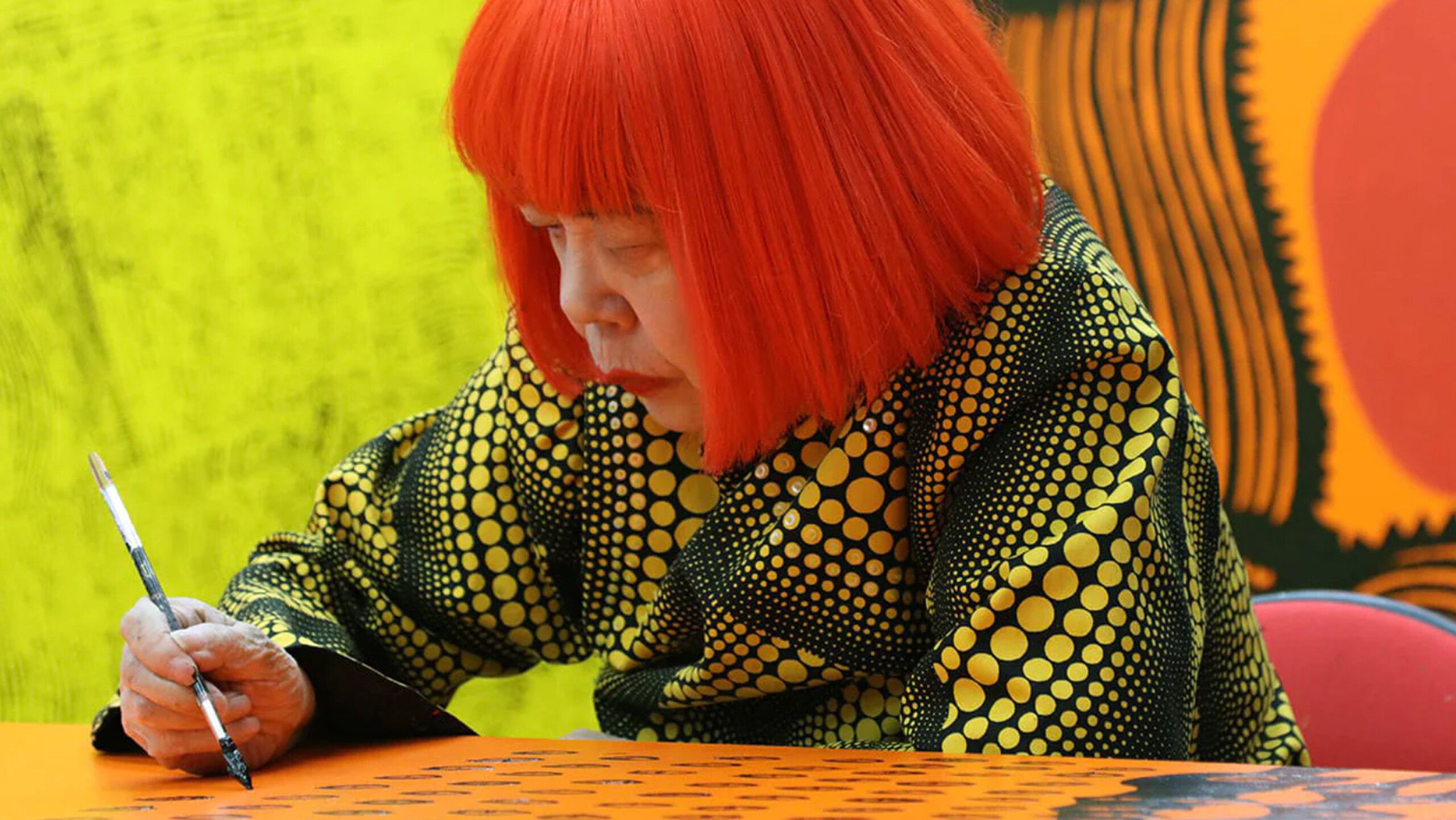 A detail from a photo of Yayoi Kusama working on My Eternal Soul paintings in her studio, Tokyo, dated 2014