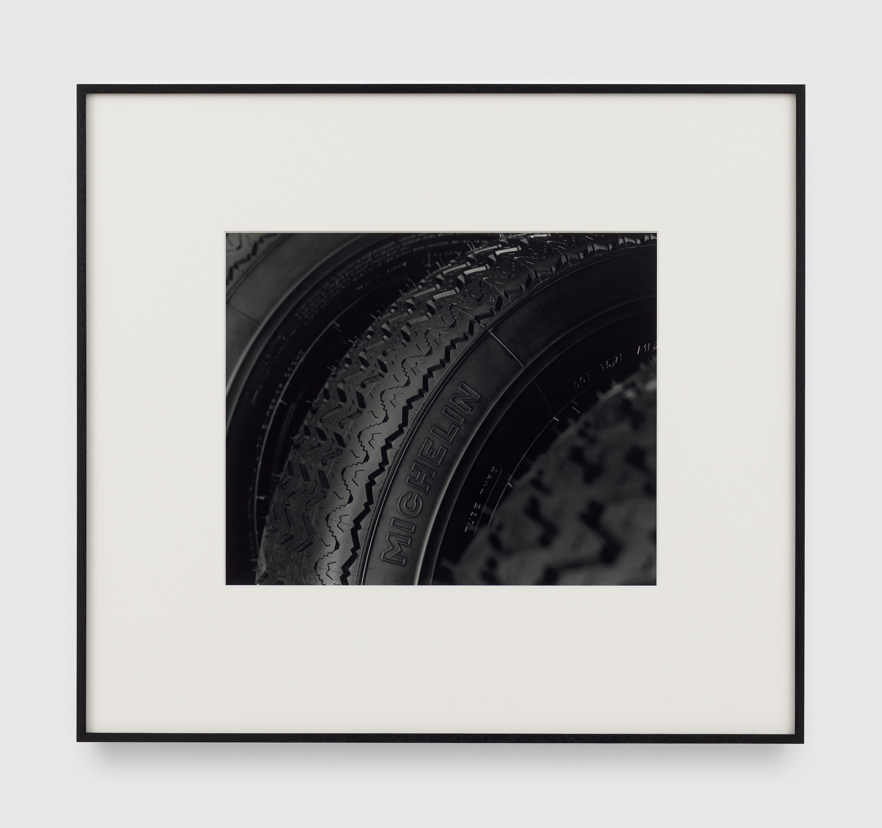 A photograph by Christopher Williams, titled 180HR15 Michelin XAS Manufactured by: Tigar Tyres d.o.o., Pirot, Serbia, Est. 1935 Parent Company: SCA Compagnie Générale des Établissements Michelin, Clermont-Ferrand, France, Est. 1889 Studio Rhein Verlag, Düsseldorf February 22, 2016, dated 2016.