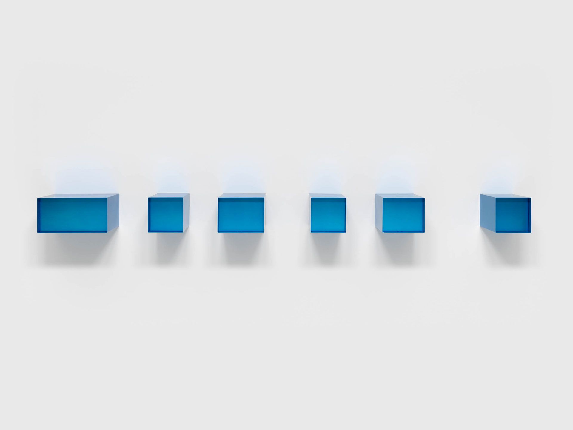An untitled blue anodized aluminum sculpture in six units by Donald Judd, dated 1973.