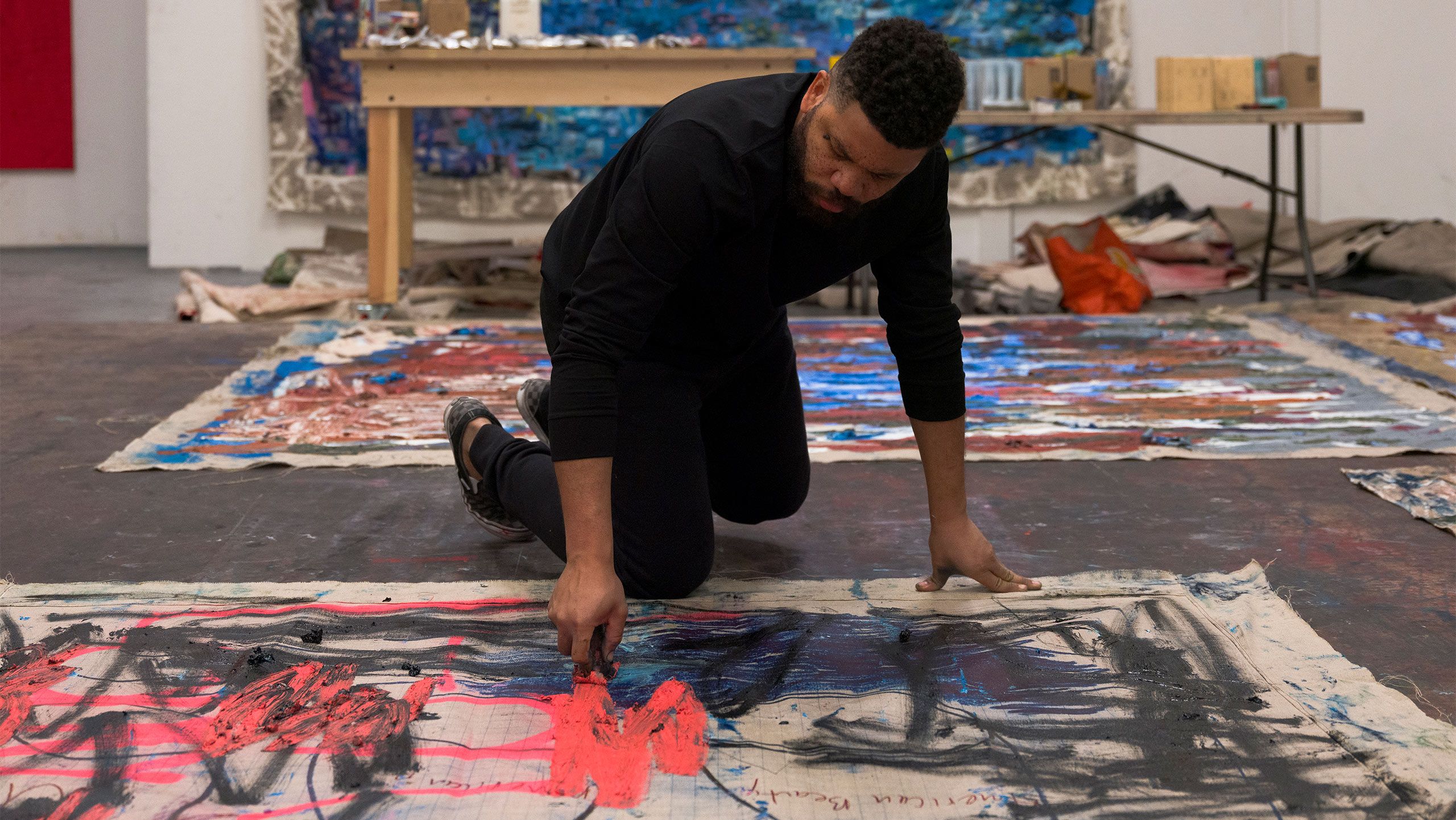 A Photo by Tim Bowditch of Oscar Murillo in his London studio, 2022. 