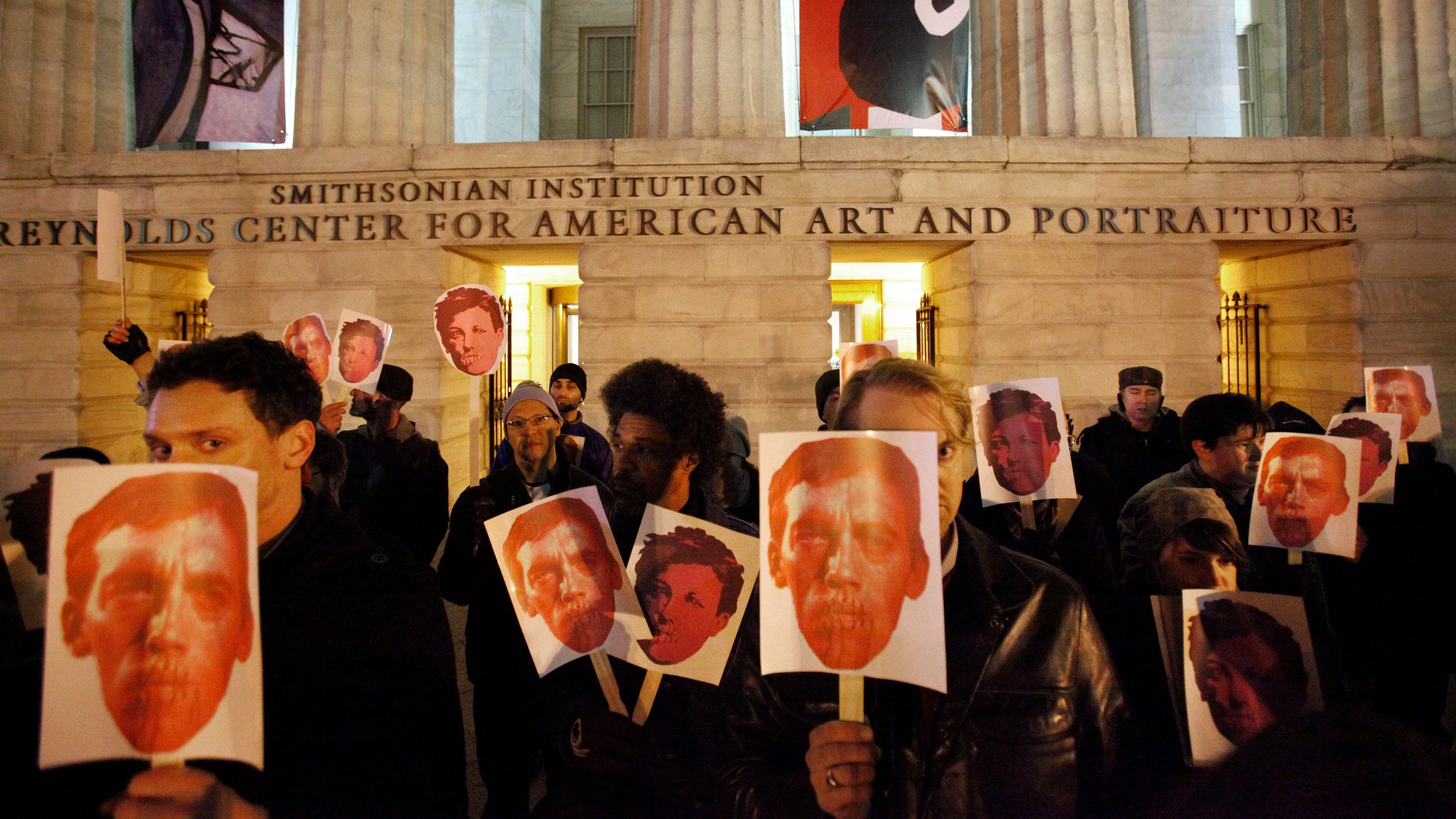 A photo of a protest against removing a David Wojnarowicz video from a National Portrait Gallery show.