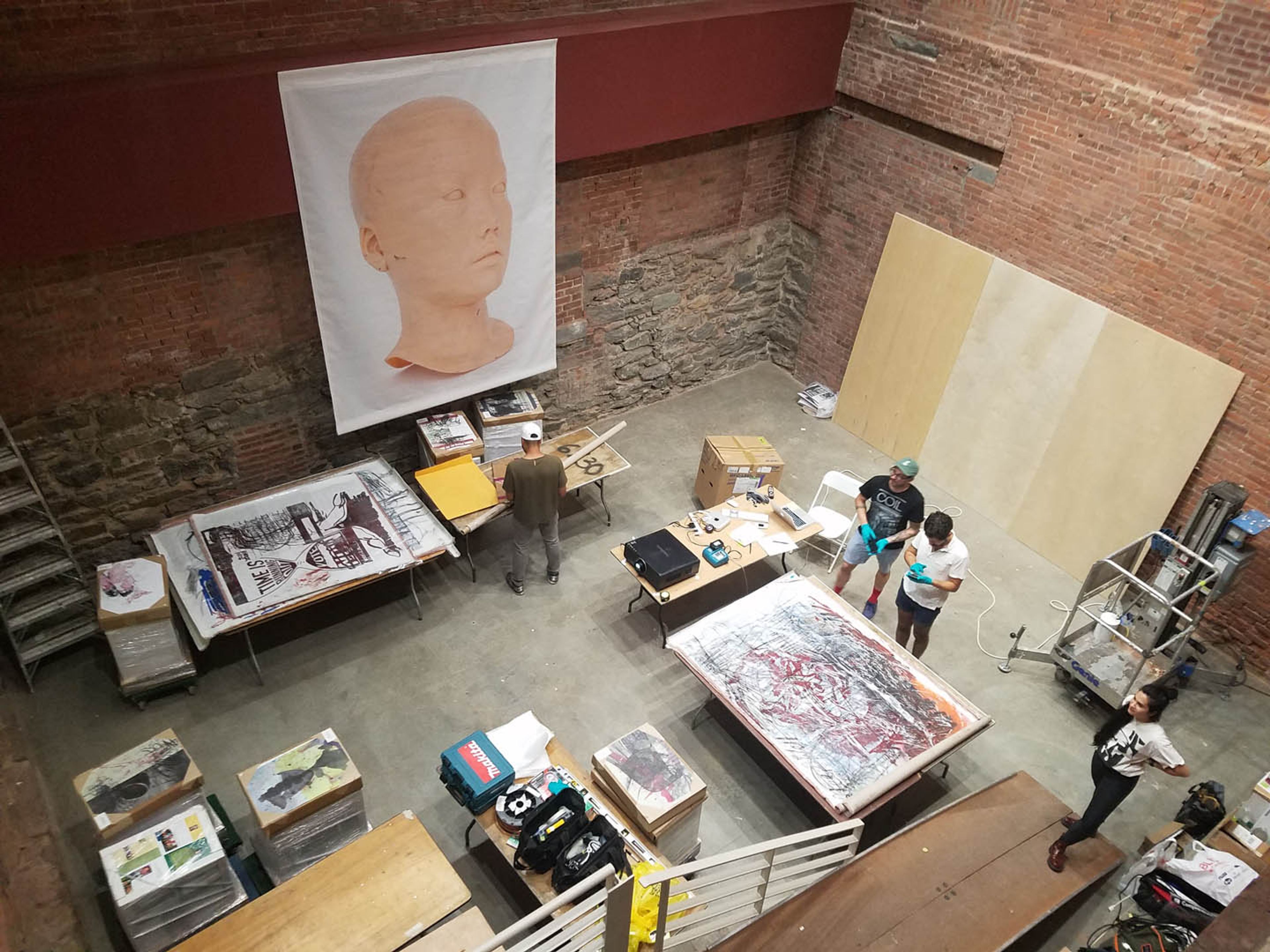 Installation view of the drawing and printing performance by Oscar Murillo, Mandy El-Sayegh and Yutaka Sone, titled Room Services at Printed Matter's New York Art Book Fair at MoMA PS1, dated 2016.