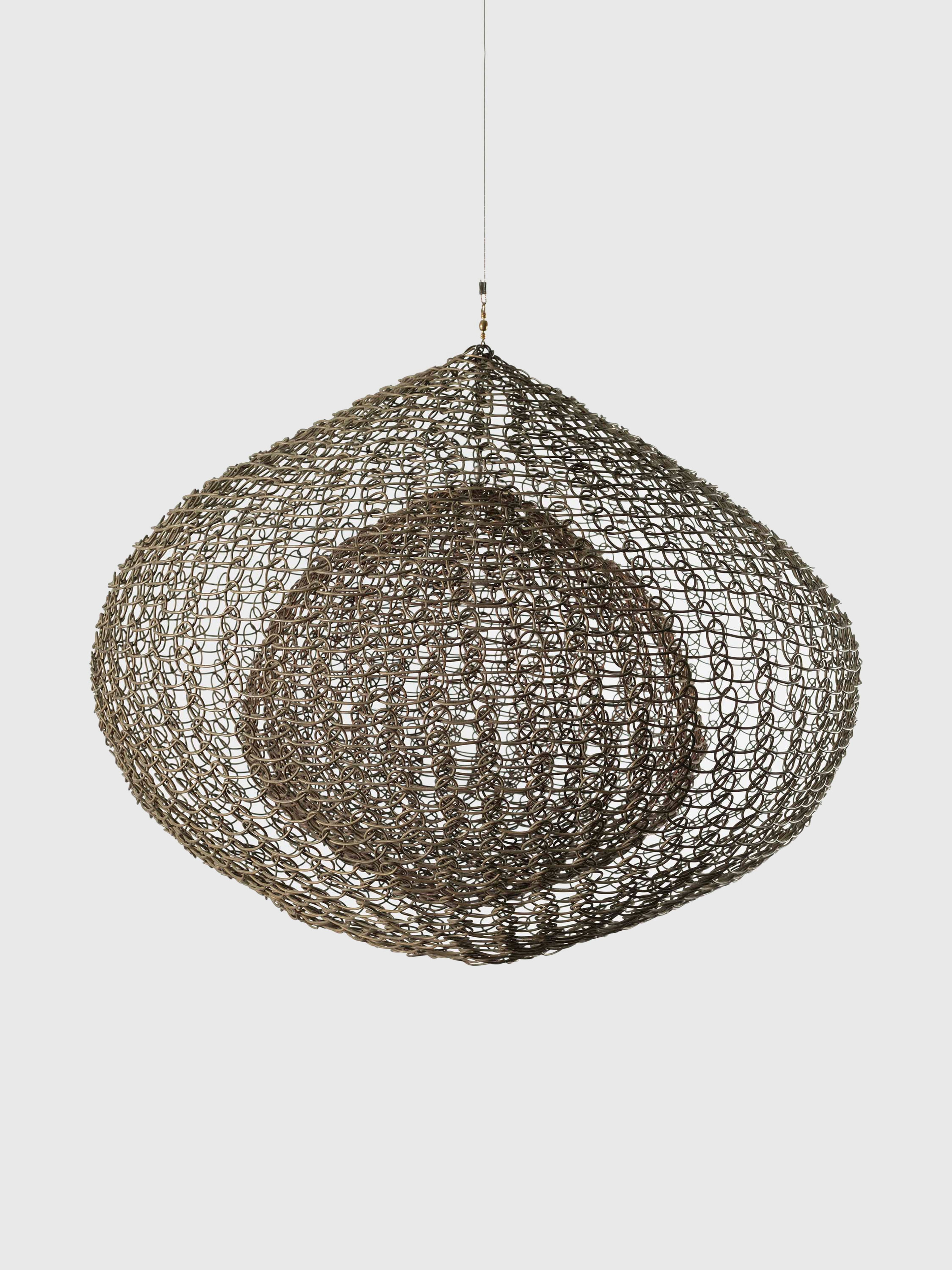 A sculpture by Ruth Asawa, called Untitled (S.068, Hanging, Single Lobe, with a Suspended Interior Sphere), dated circa 1952.