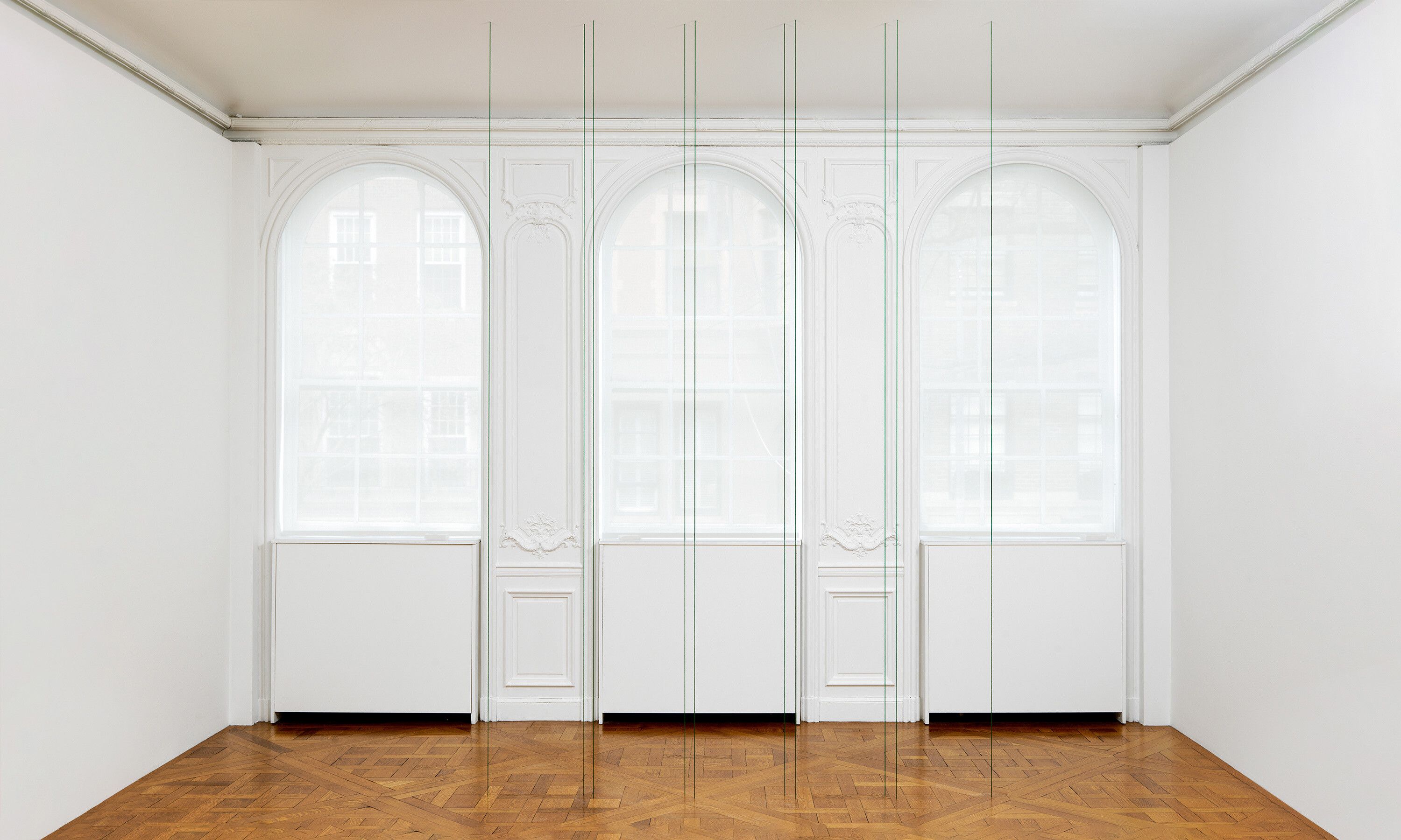 A green acrylic yarn artwork by Fred Sandback, titled Untitled (Sculptural Study, Ten-part Vertical Construction), circa 1983 and 2017.