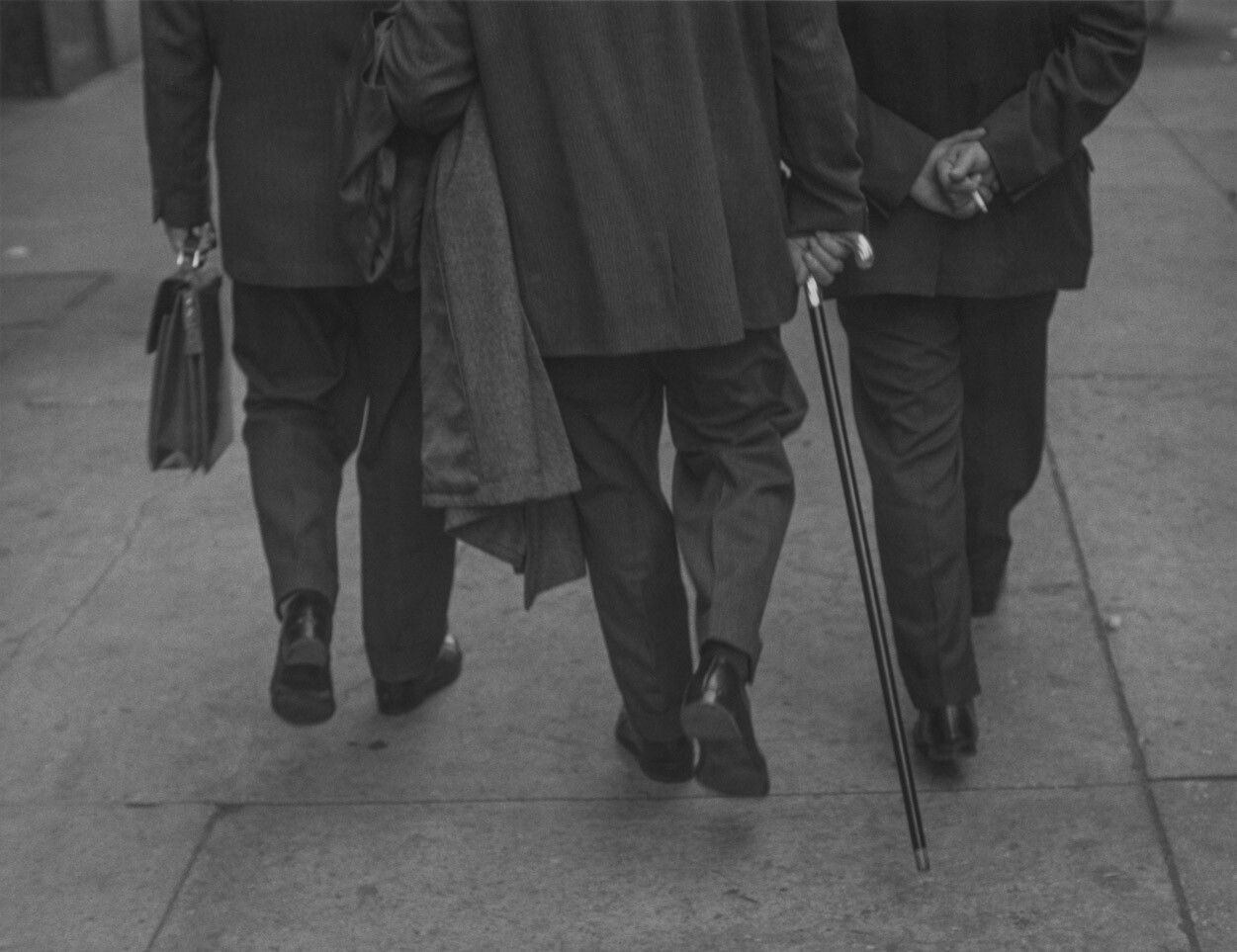 A silver gelatin print by Roy DeCarava, titled Three men walking, dated 1961.
