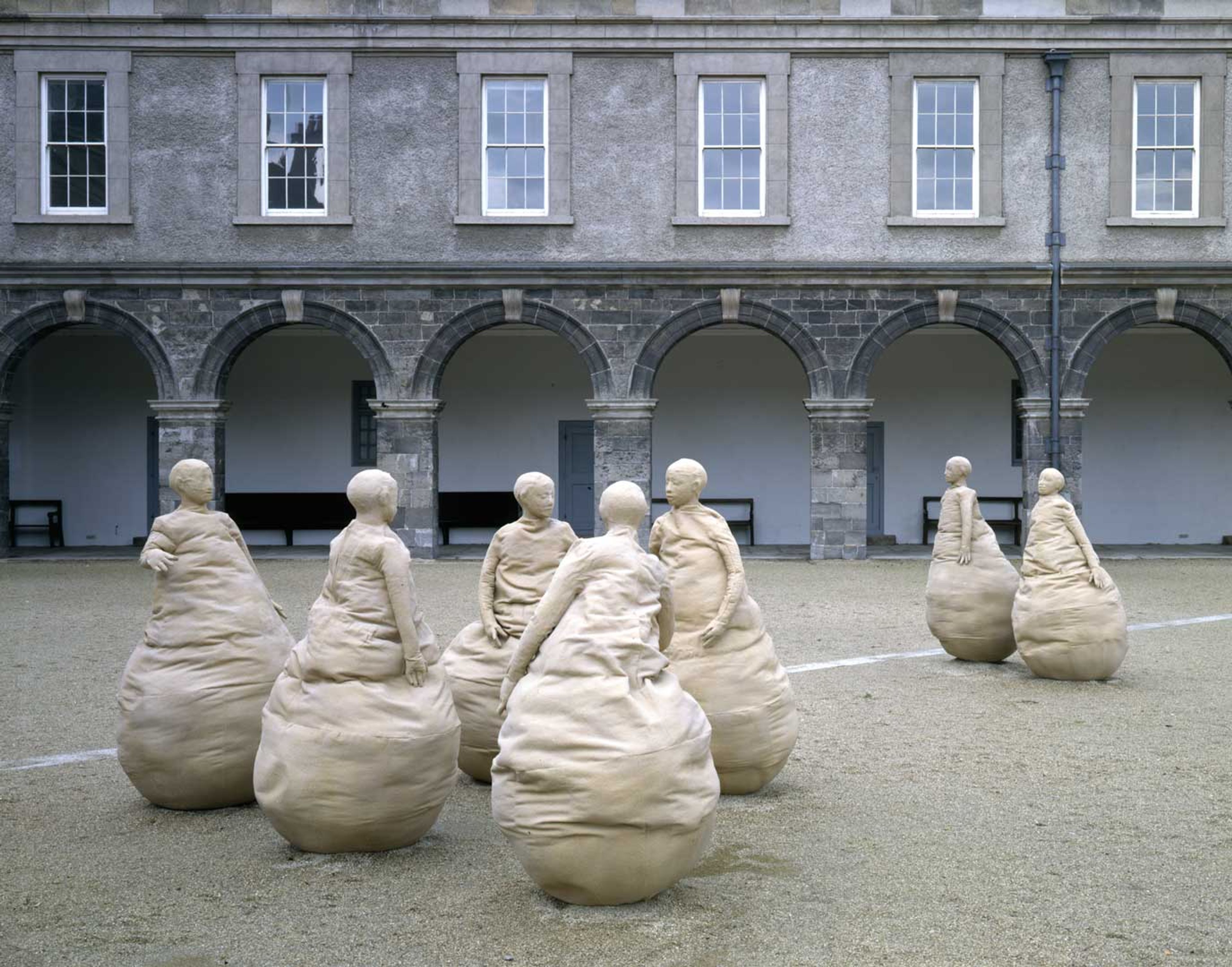 A mixed media outdoor sculptural installation by Juan Muñoz, titled Conversation Piece, Dublin, dated 1994, at the Irish Museum of Modern Art, Dublin, in 1994. 