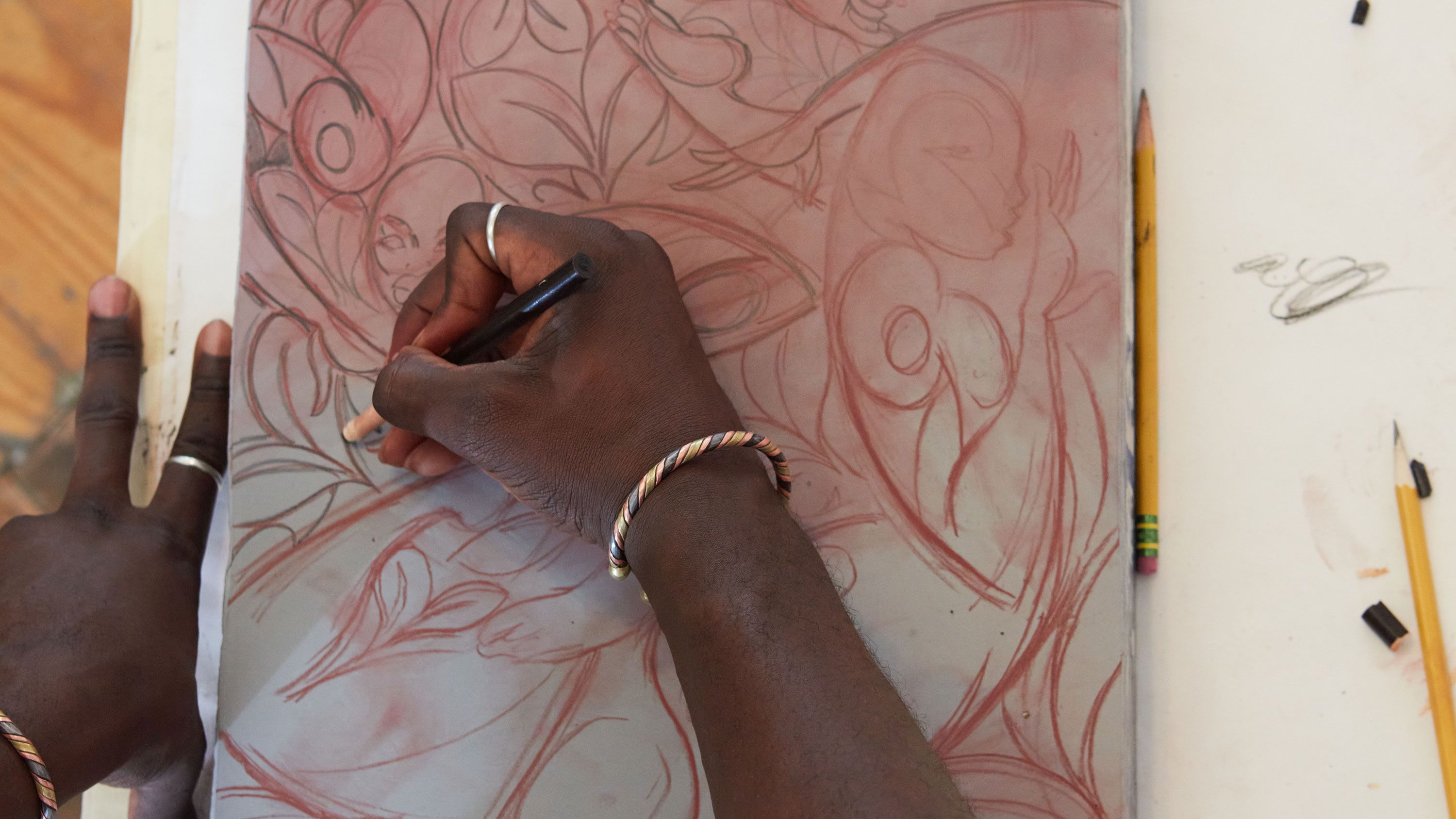 This photograph features Adeniyi-Jones drawing with a greasy crayon on a limestone slab as part of the stone lithography process, photo by Rafael Rios