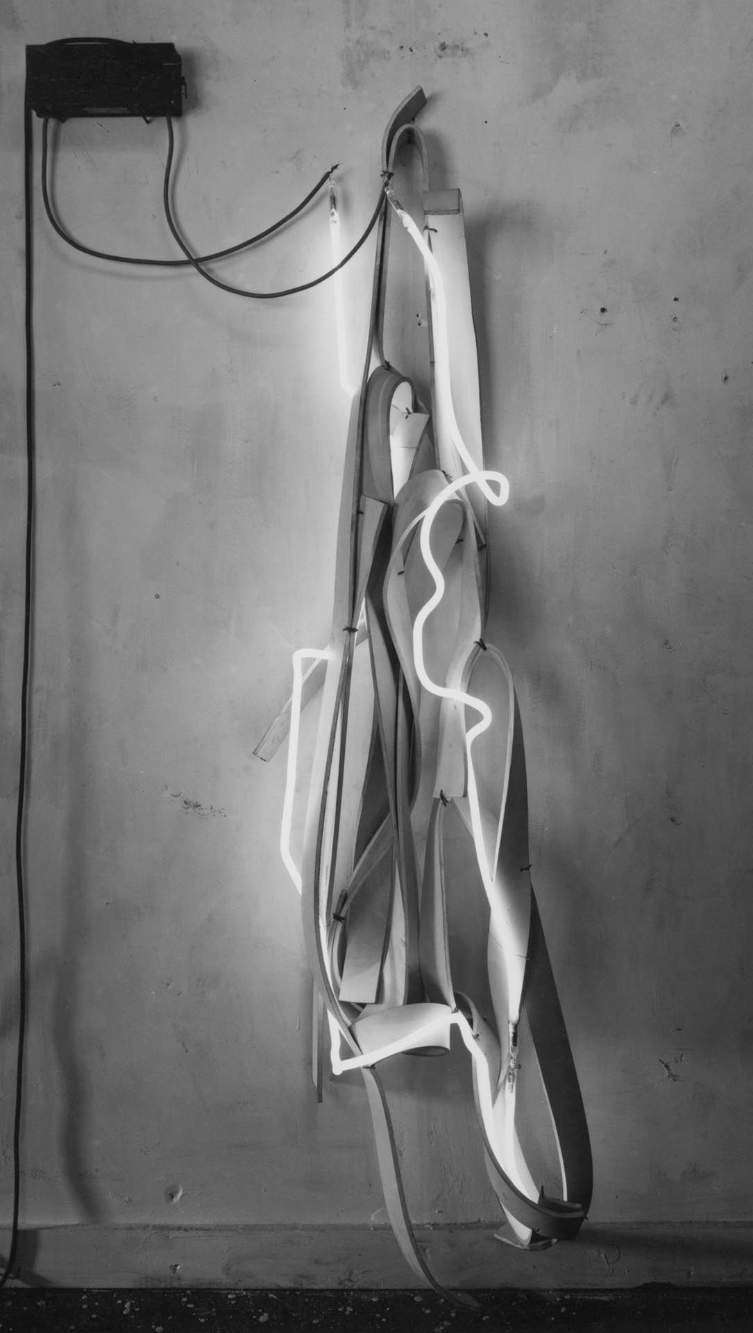 A mixed media sculpture by Richard Serra, titled White Neon Belt Piece, dated 1967.