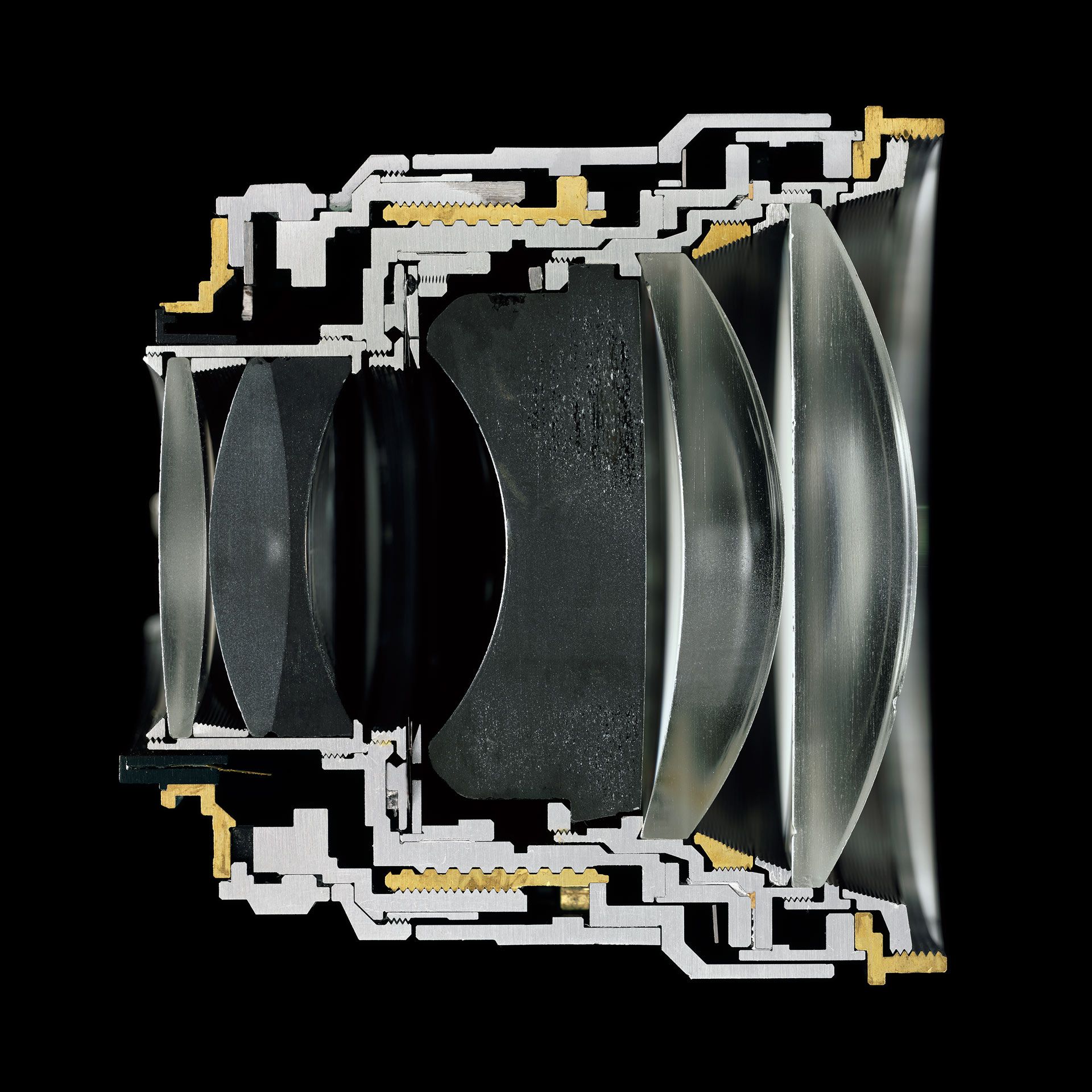 A color photograph depicting a camera lens sliced in half, by Christopher Williams, dated 2016.