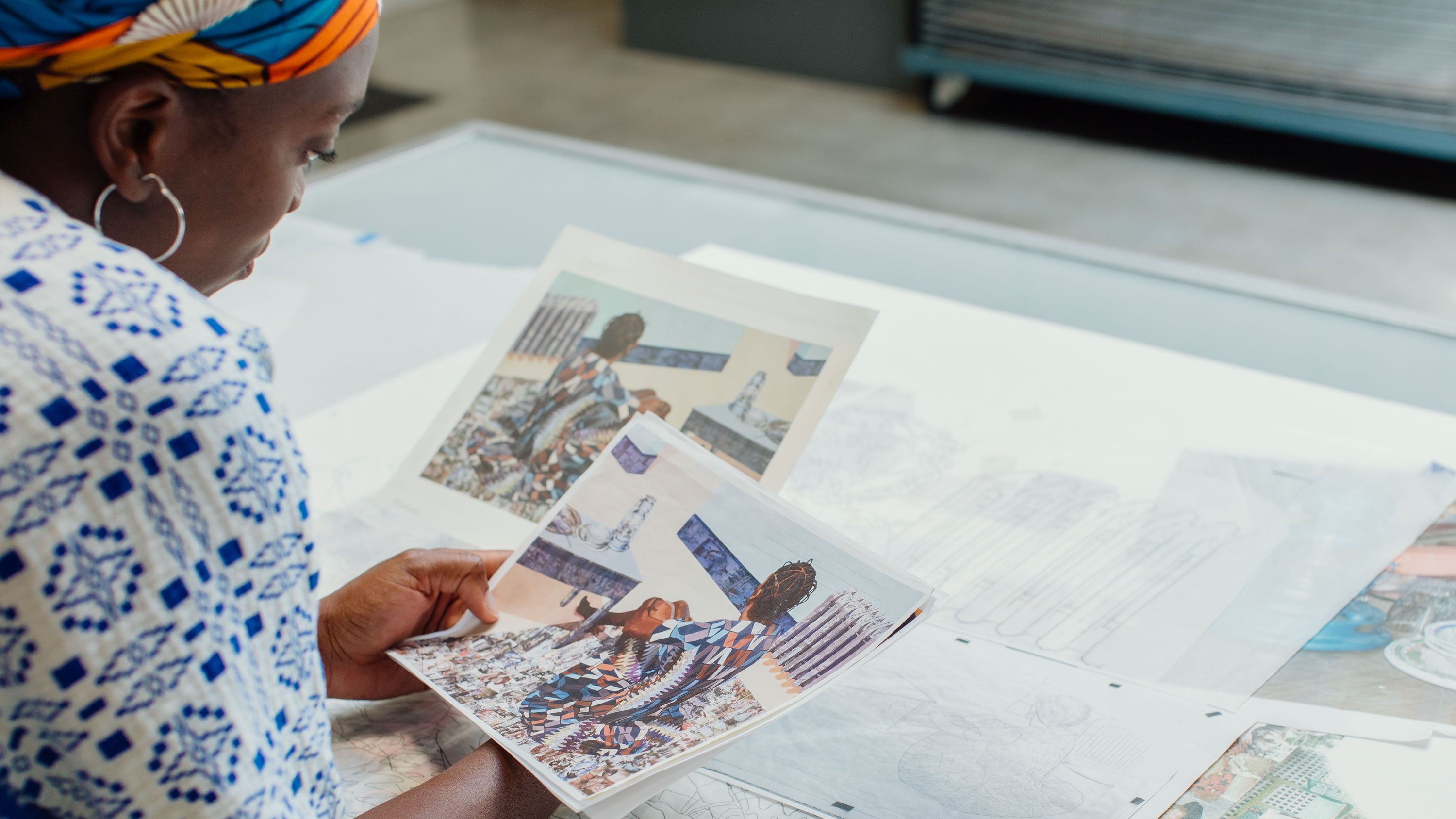 An image of Akunyili Crosby reviews reference images for her print. Photo by Bobby Rogers