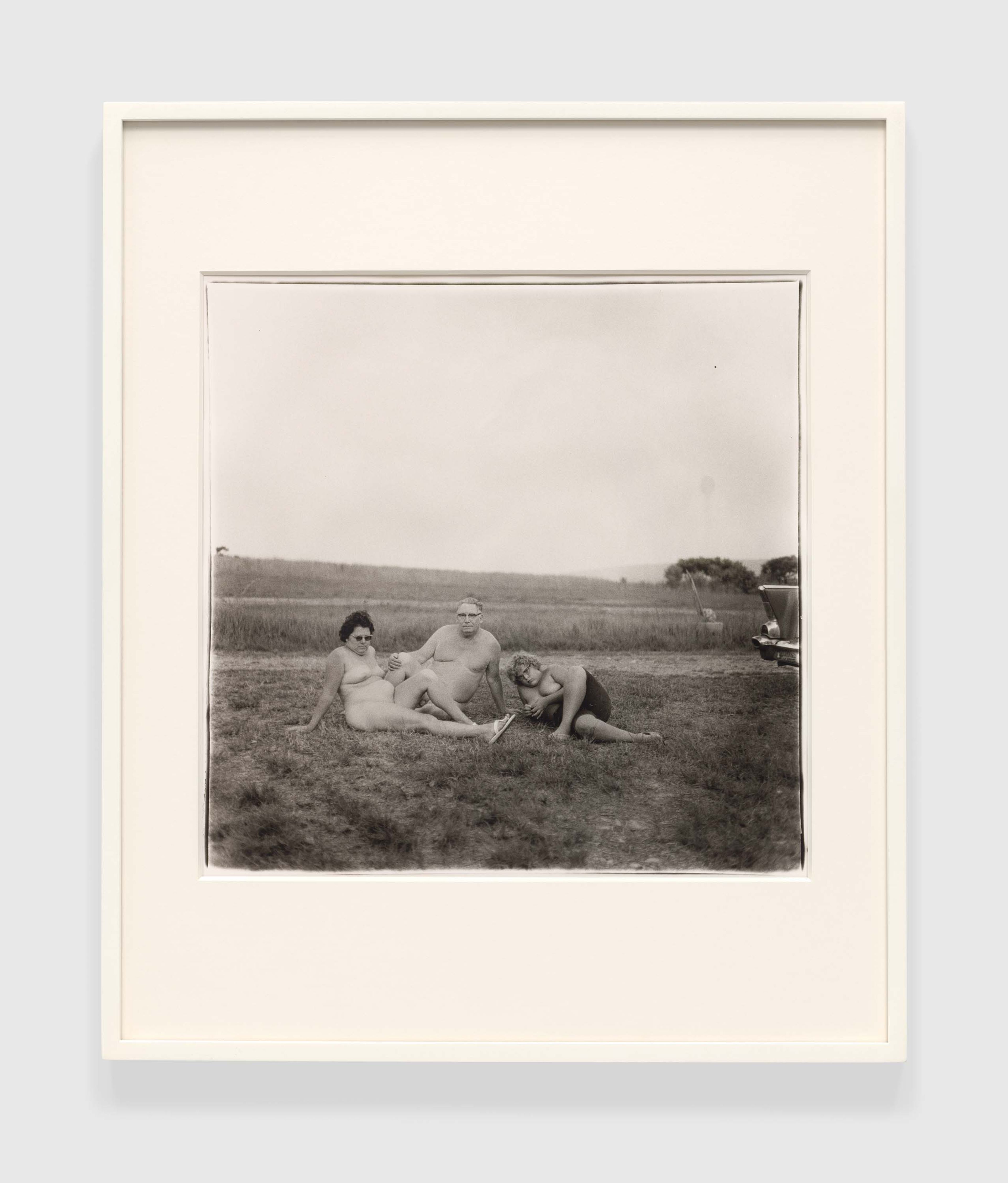 A gelatin silver print by Diane Arbus, titled A family one evening in a nudist camp, Pa. 1965, dated 1965.