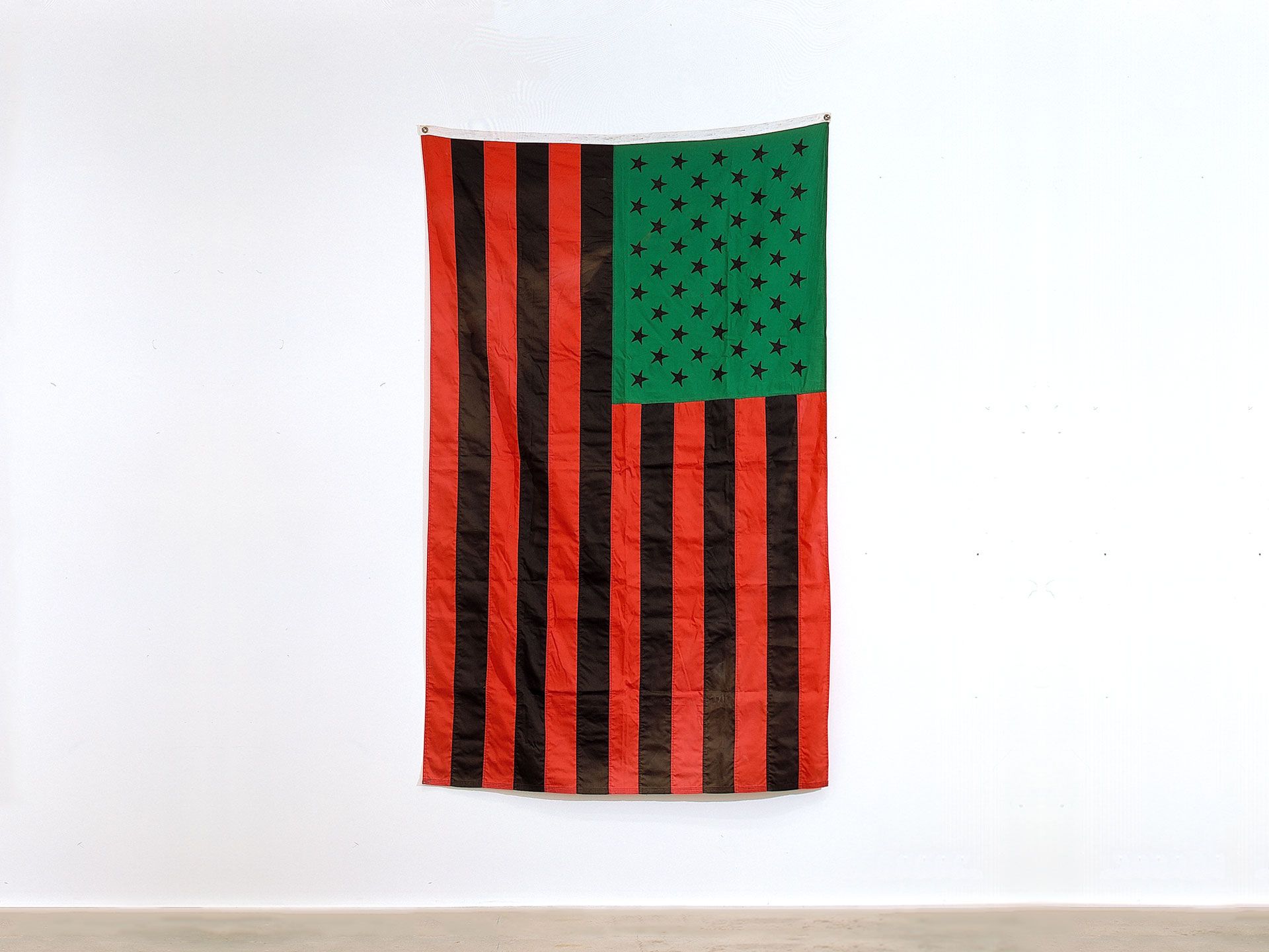A fabric sculpture by David Hammons, titled U.N.I.A. Flag, dated 1990.