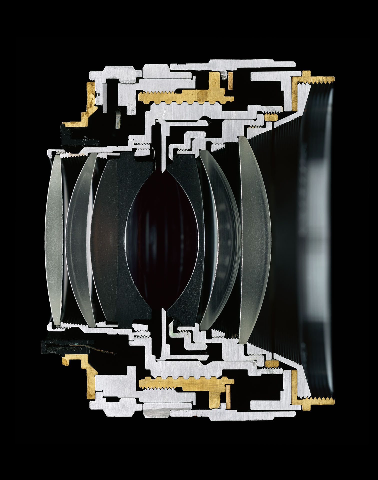 A color photograph depicting a camera lens sliced in half, by Christopher Williams, dated 2016.