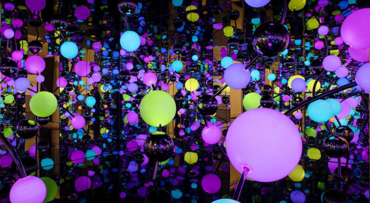 An installation view of an exhibition titled Yayoi Kusama: A Retrospective – A Bouquet of Love I Saw in the Universe, at Gropius Bau in Berlin in 2021.