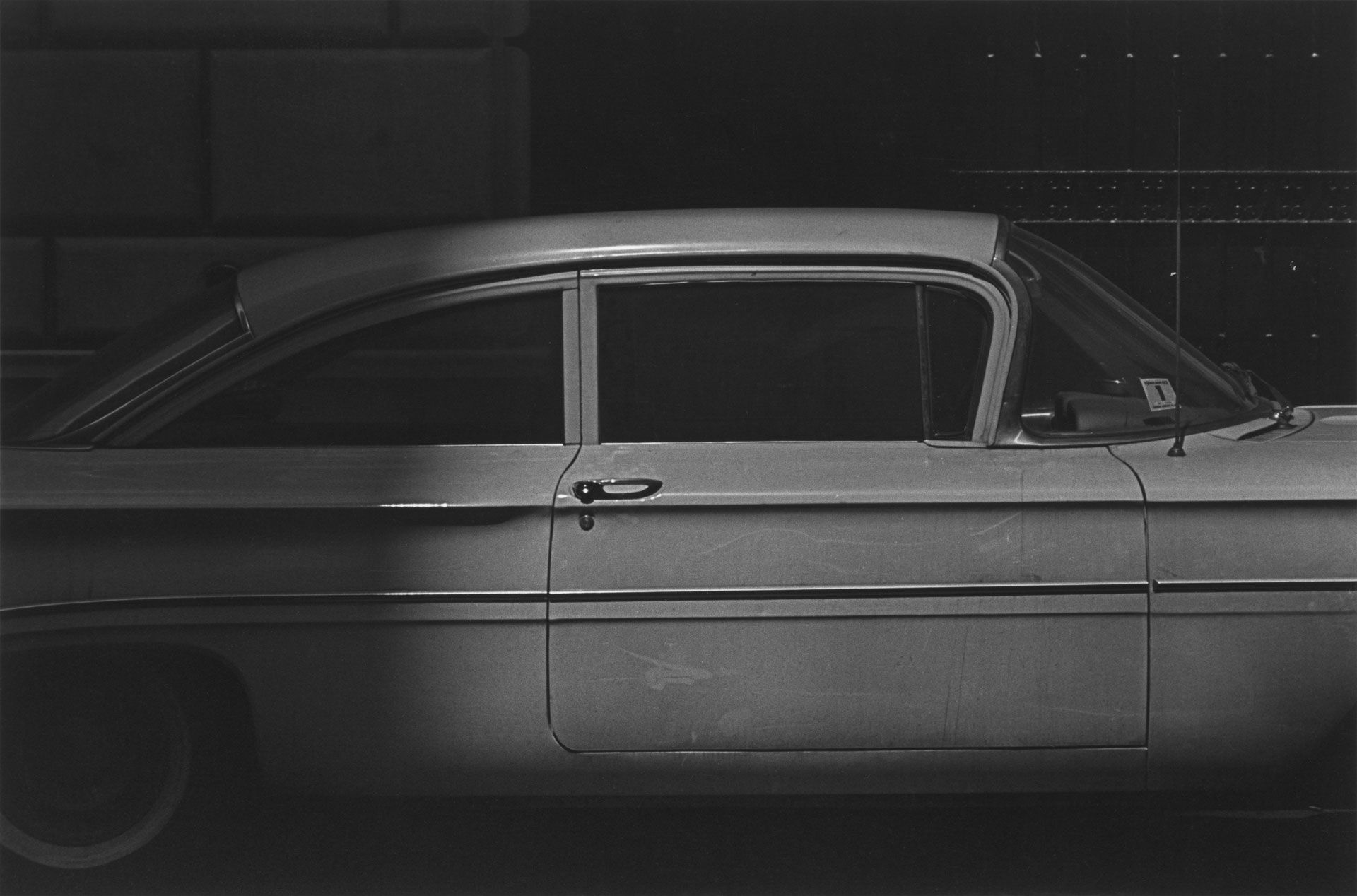 A silver gelatin print by Roy DeCarava, titled White car and dots, dated 1961.