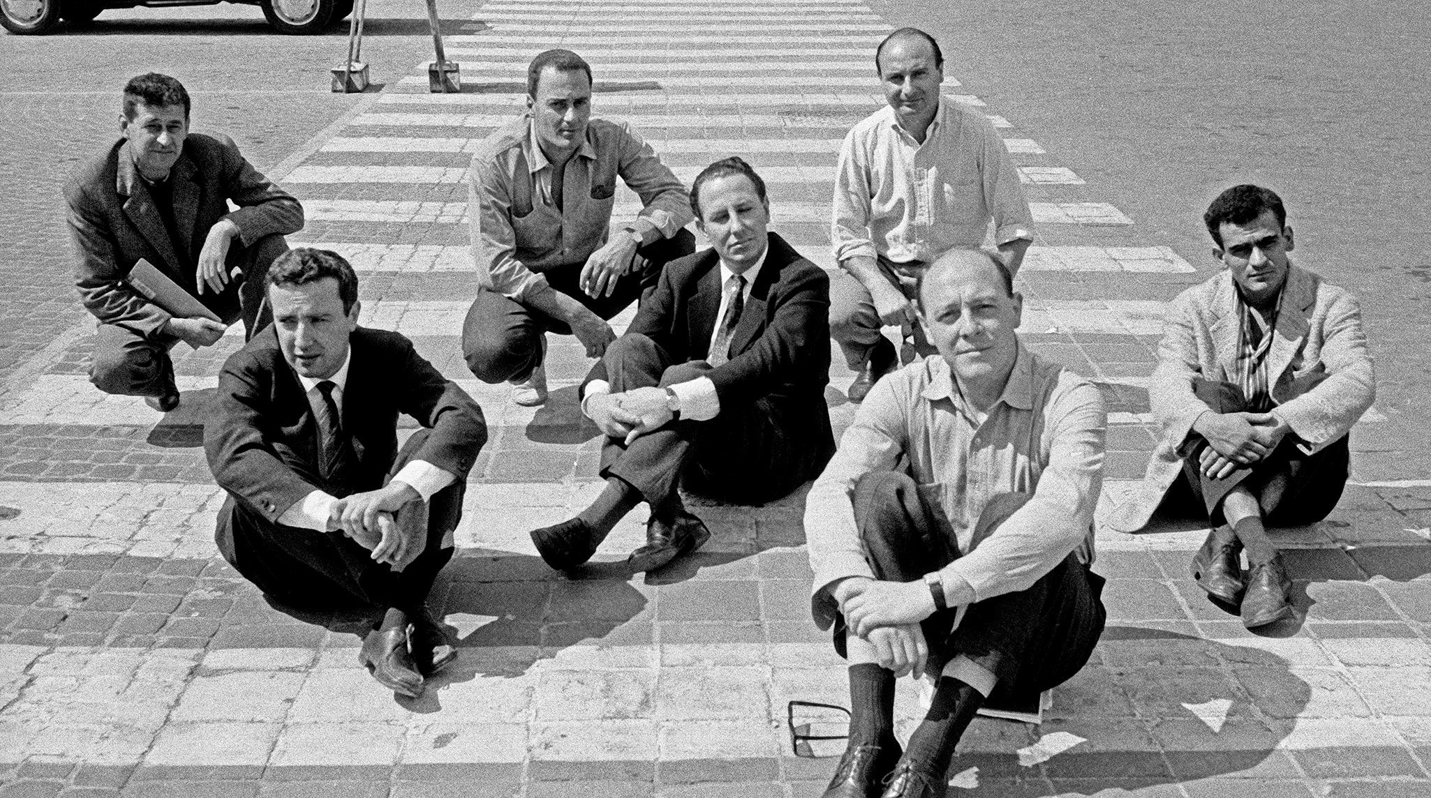 A photo of Members of the “Crack” artist group, Piazza del Popolo, Rome, 1960; from left to right: Giulio Turcato, Achille Perilli, Gastone Novelli, Fabio Mauri, Mimmo Rotella, Piero Dorazio, and Gino Marotta.