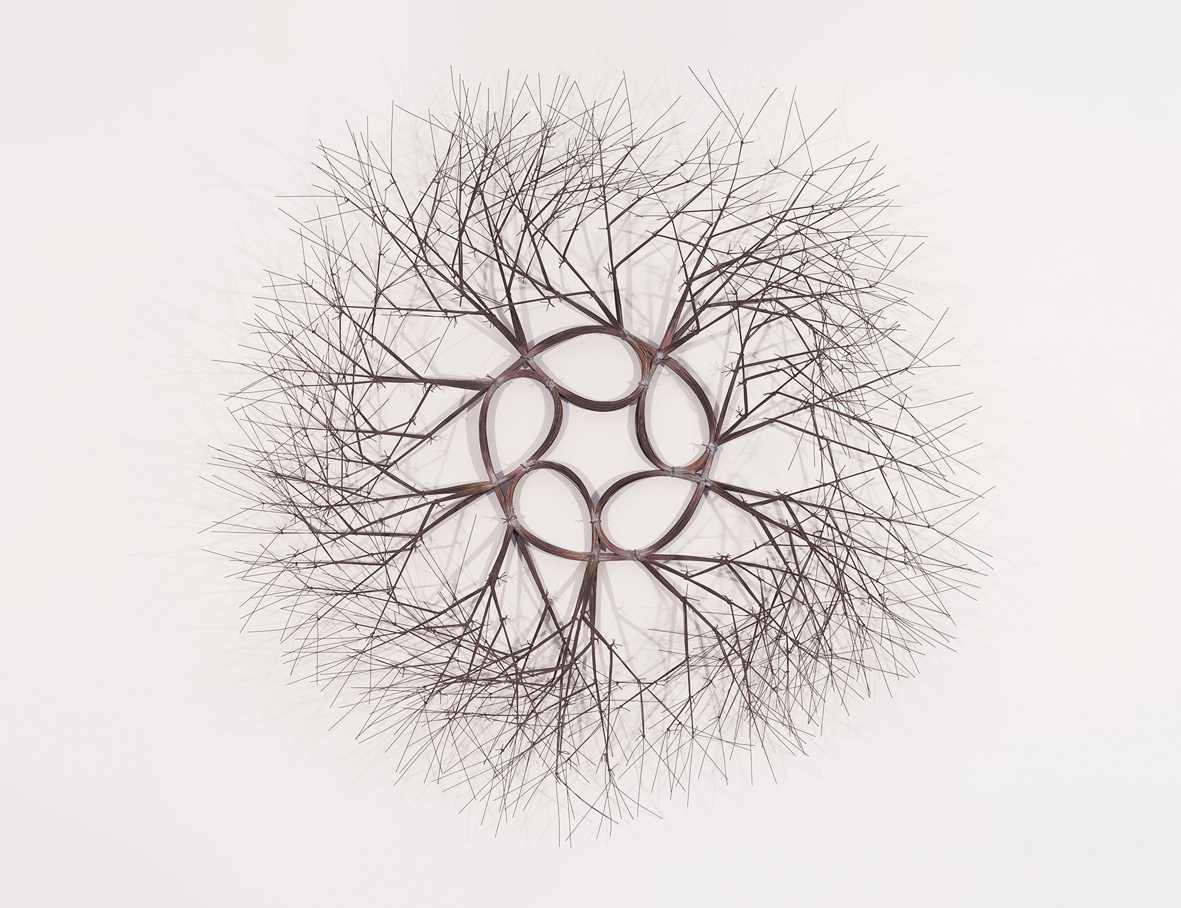 A wall-hanging wire sculpture by Ruth Asawa, titled Sun and Star (S.616/60), circa 1966.