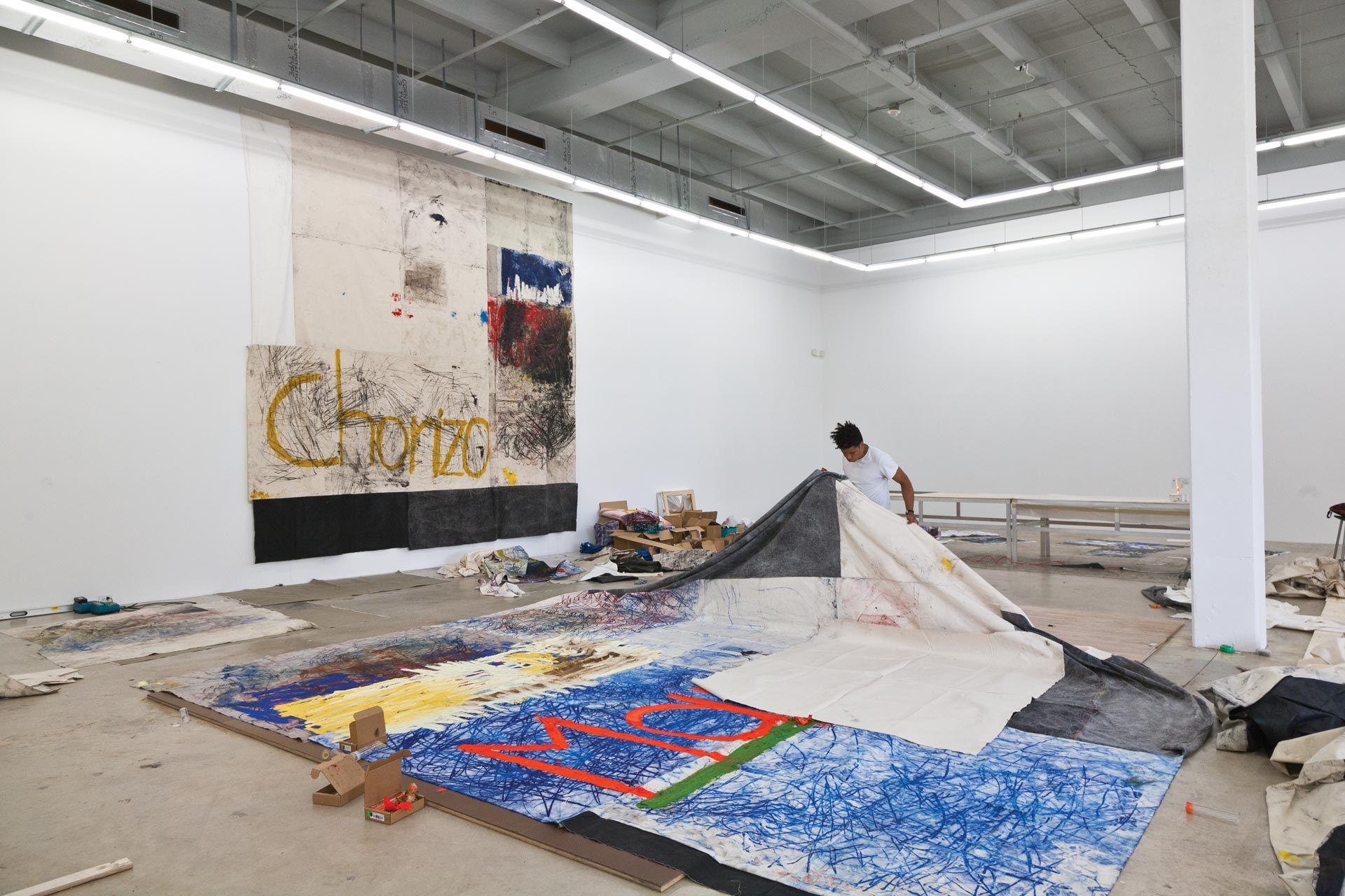 A photo of Oscar Murillo in his studio.