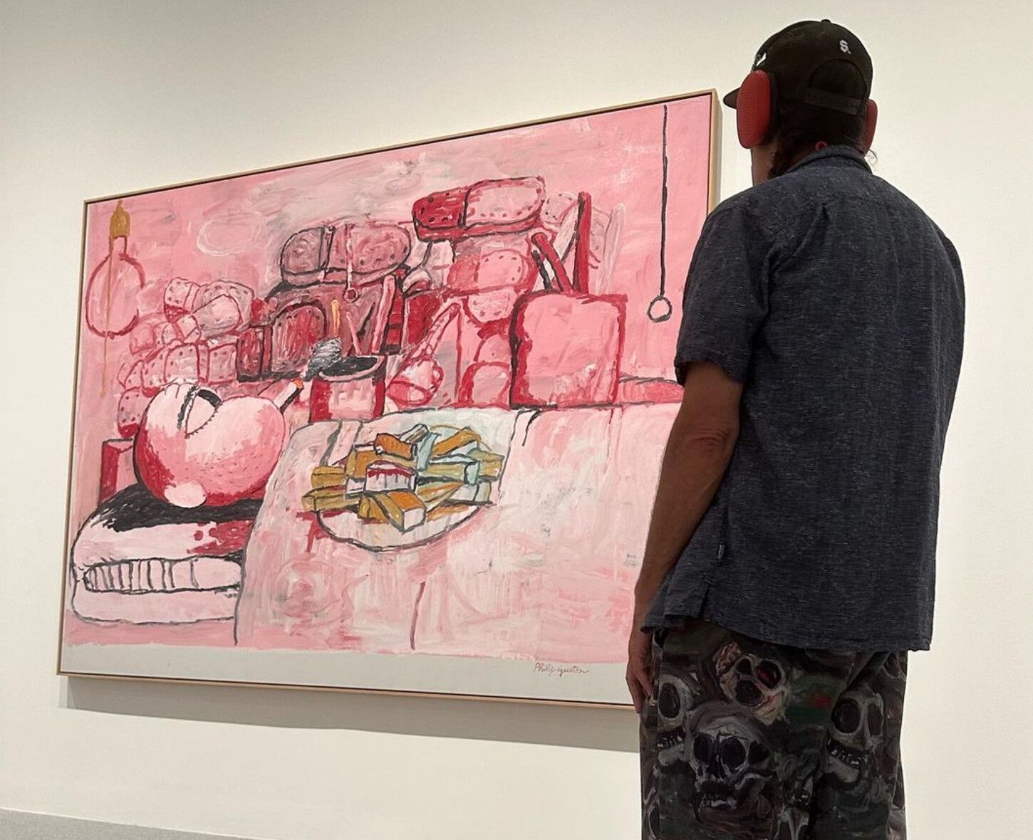 Josh Smith standing in front of a Guston painting